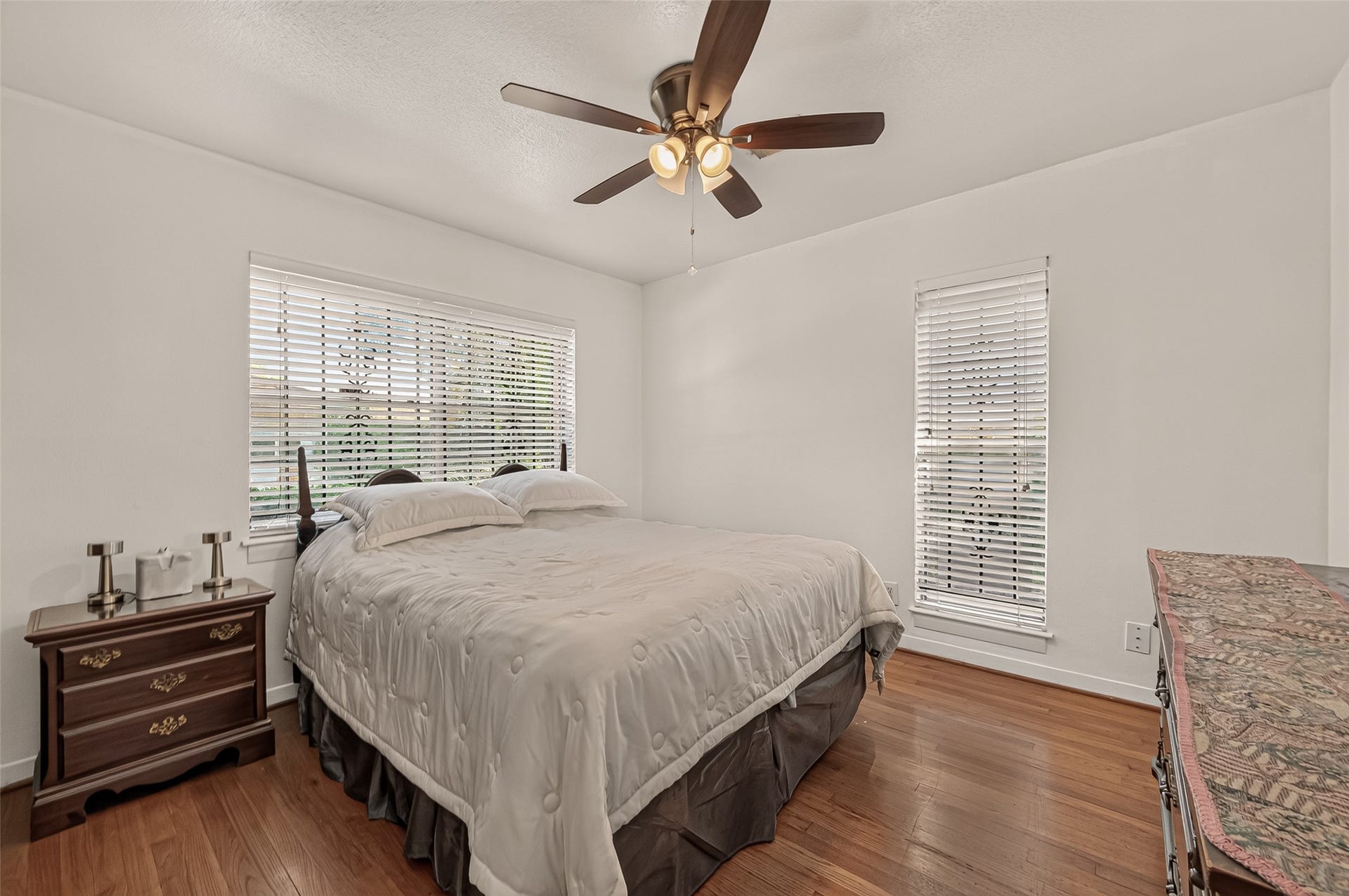 6655 Wildwood Way, Houston, TX 77023 Secondary Bedroom. Original hardwood floor. Natural light from the large windows.
