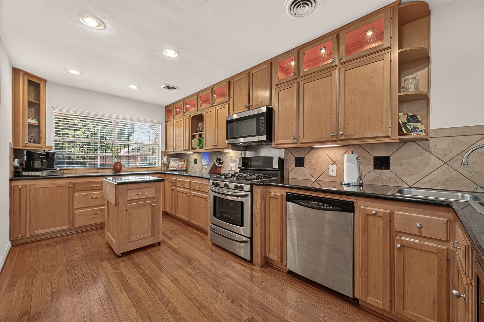 6655 Wildwood Way, Houston, TX 77023 Updated Kitchen,Stainless/Black appliances. Abundance of cabinets and storage. Island cabinet is on rollers for convenient access anywhere in the kitchen.