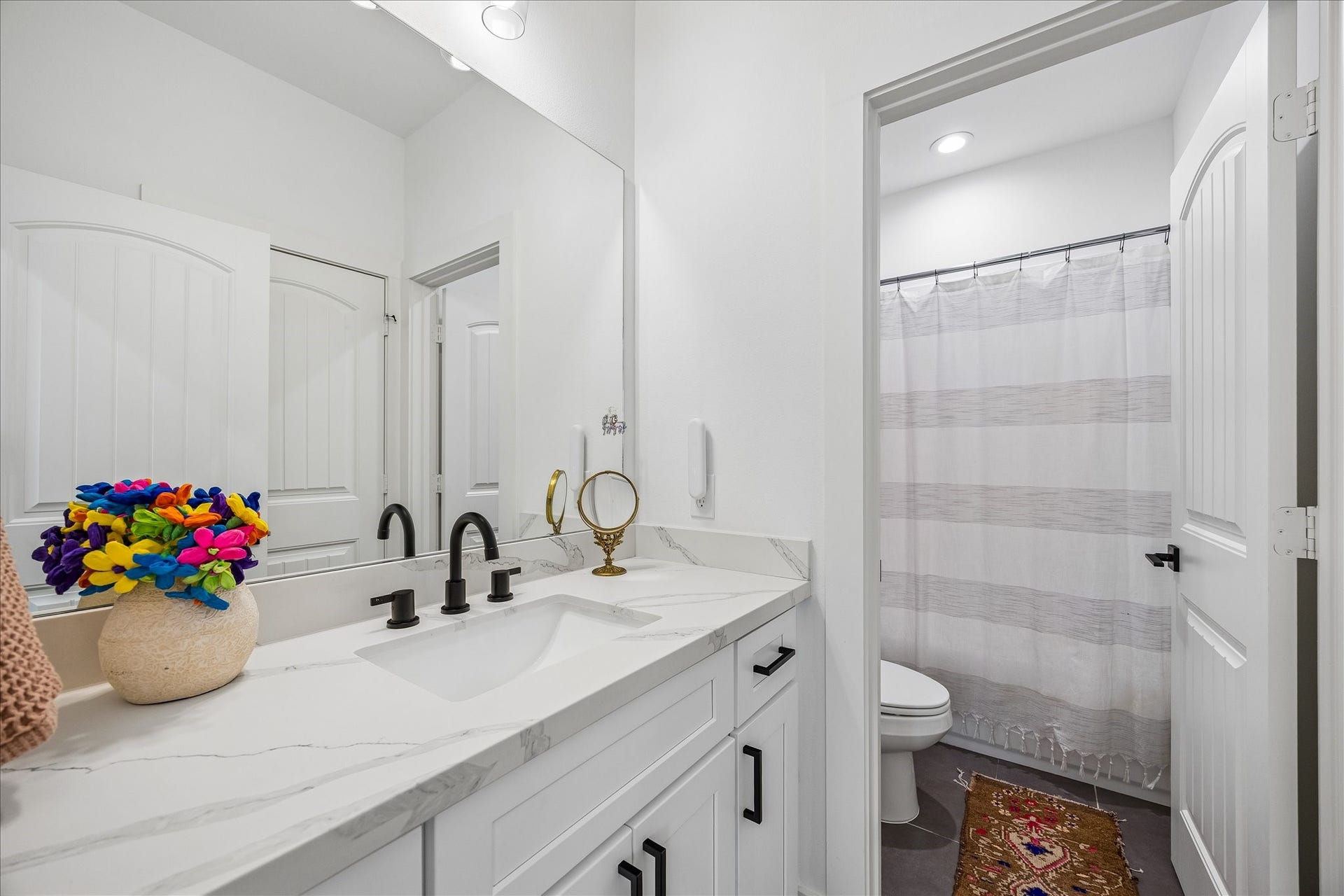 2320 Couch Street, Houston, TX 77008 No throwing elbows here! A quartz topped vanity with ample storage, a full mirror and stylish vanity lights gives everyone plenty of room to get ready, while the separate water closet with tub/shower and toilet adds a little extra privacy when you need it.