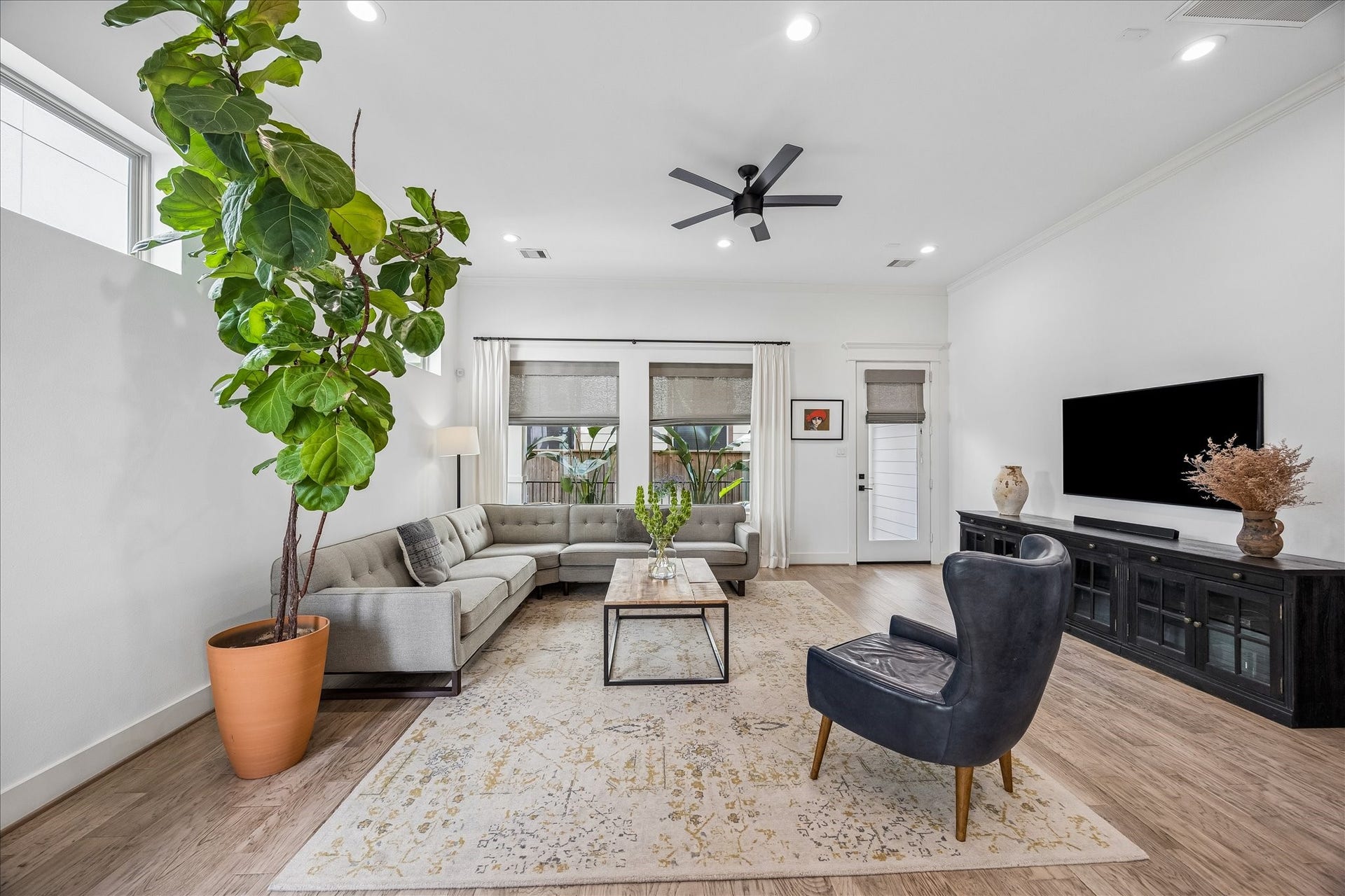 2320 Couch Street, Houston, TX 77008 This living room makes it easy to settle in and stay awhile. Warm engineered wood flooring, custom window coverings, abundant natural light, recessed lighting and a sleek modern ceiling fan give the space a welcoming feel with just the right amount of polish.