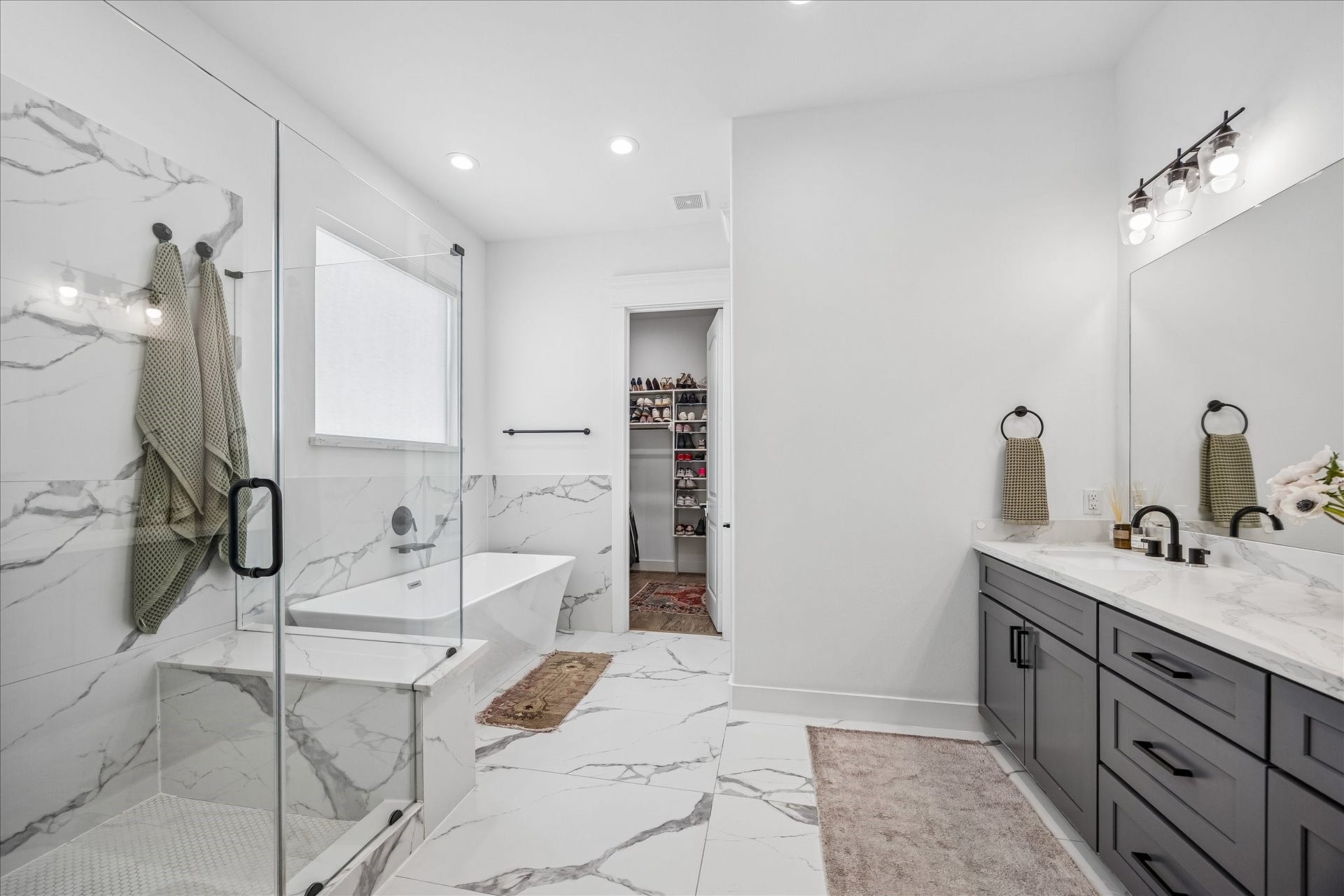 2320 Couch Street, Houston, TX 77008 Bring a little spa vibe to every morning and evening in this beautifully finished ensuite. The glass enclosed shower, freestanding soaking tub, elegant marble finishes and sleek dual sink vanity offer a daily dose of luxury right at home.
