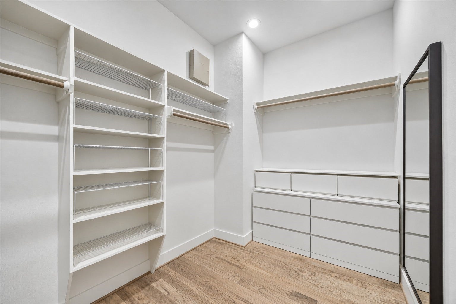 2320 Couch Street, Houston, TX 77008 Closet goals, achieved. This spacious walk-in closet offers hanging space, shelving and built-in drawer storage, giving everything from belts to travel bags a place to land. This is only part of the story here with a second large walk-in closet in the primary suite. This photo is virtually staged to remove personal items.