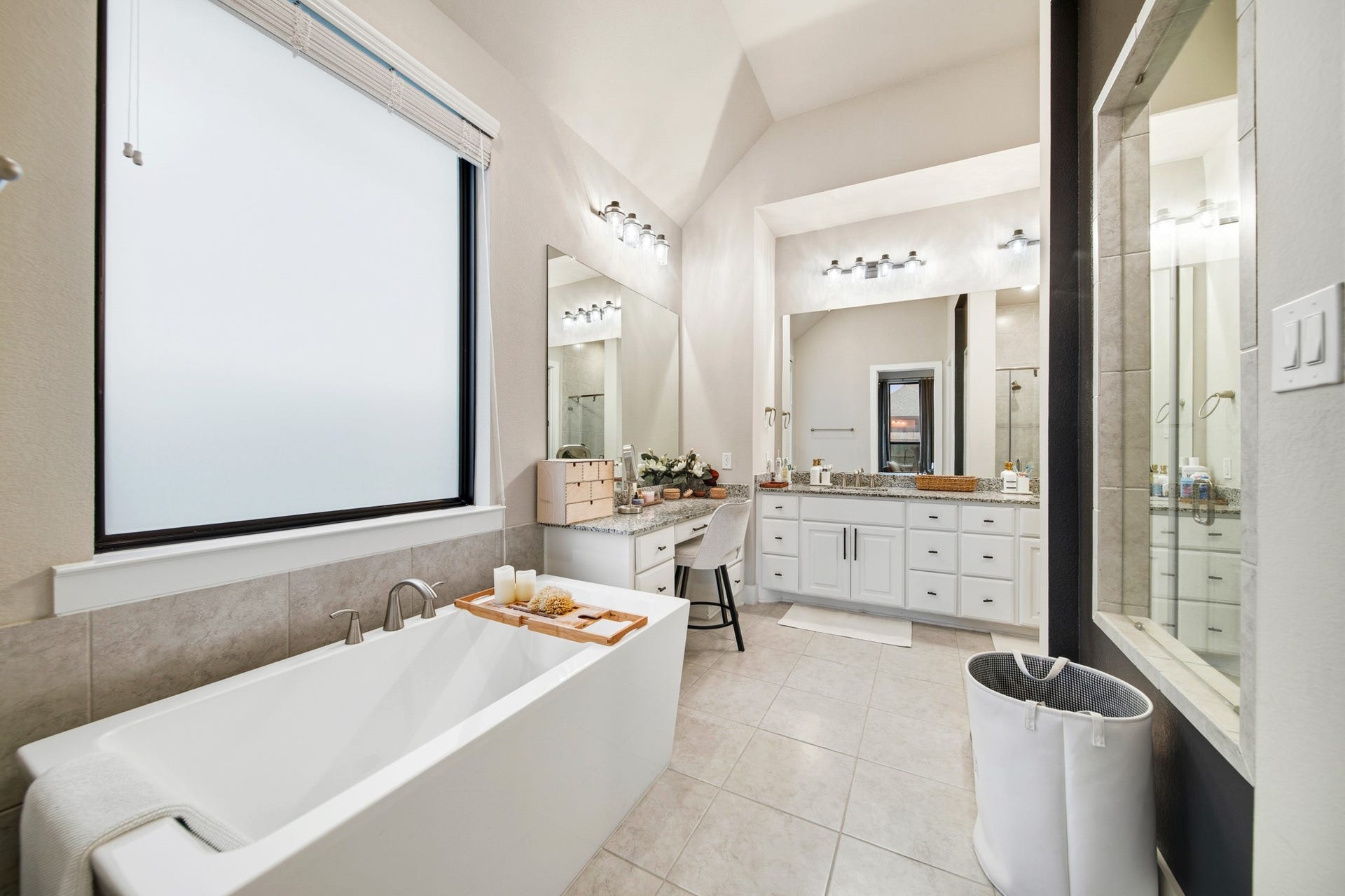 Huge Primary bathroom with freestanding soaking tub and separate makeup vanity.