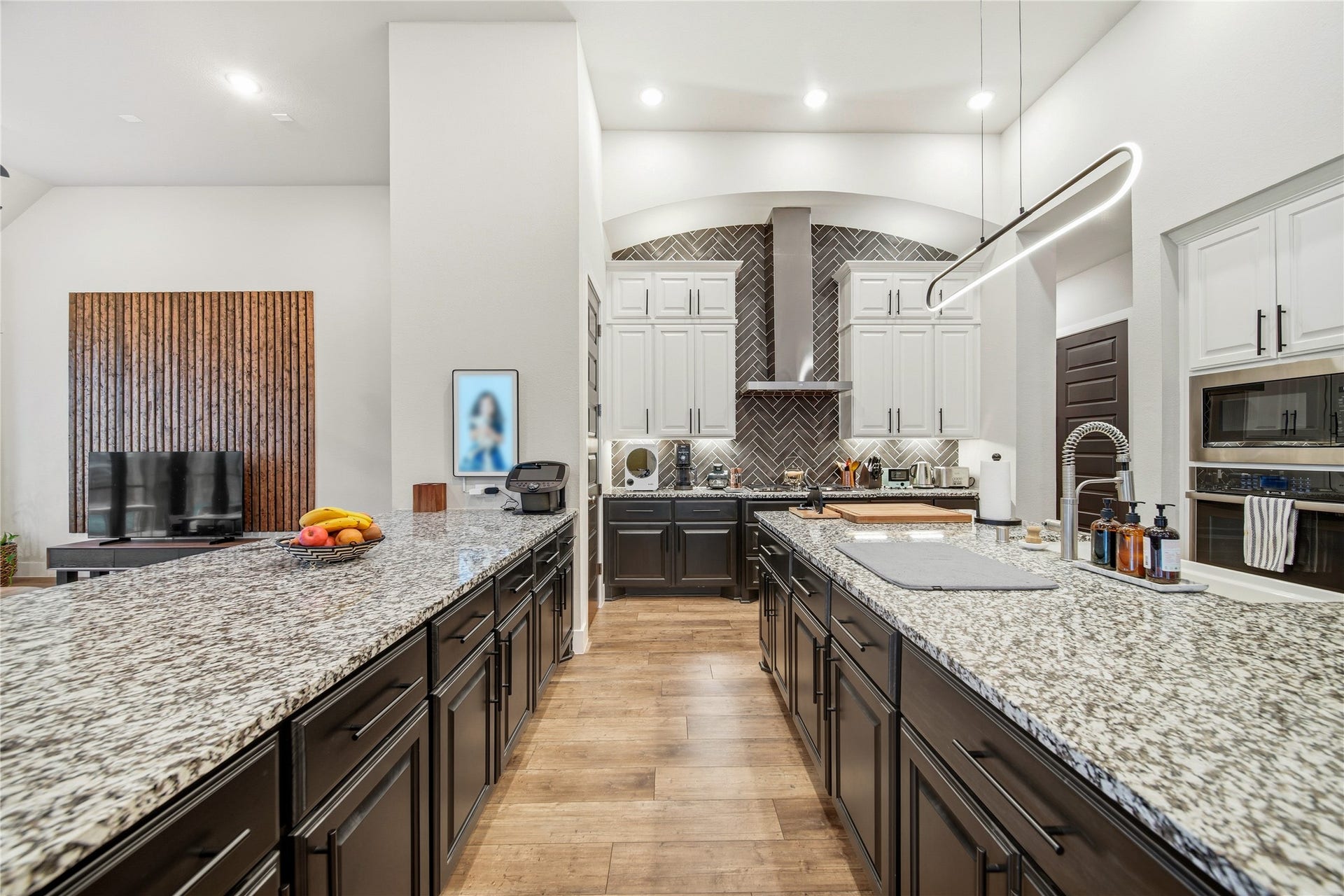 This granite countertop peninsula allows for more storage space and a sitting area to connect with the family room.