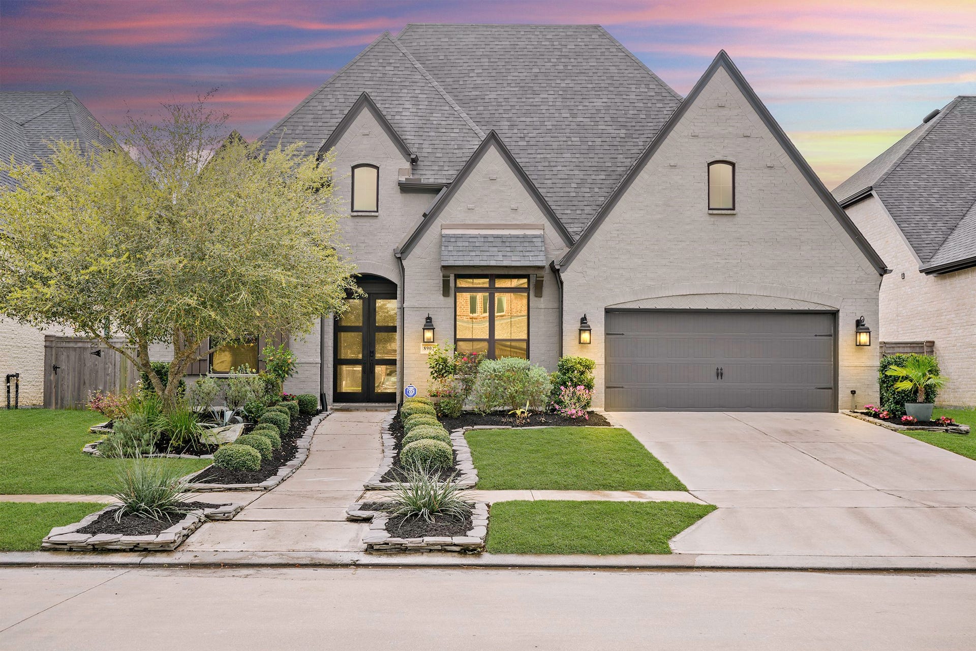 Twilight view of the home. 3-car tandem garage is climate controlled for cooling and heating.
