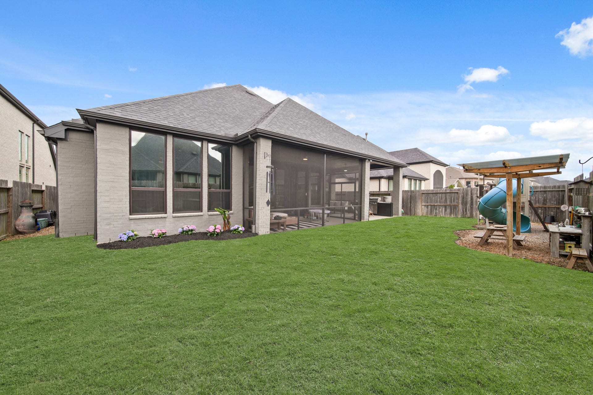 Backyard includes playground area, gazebo and storage shed.