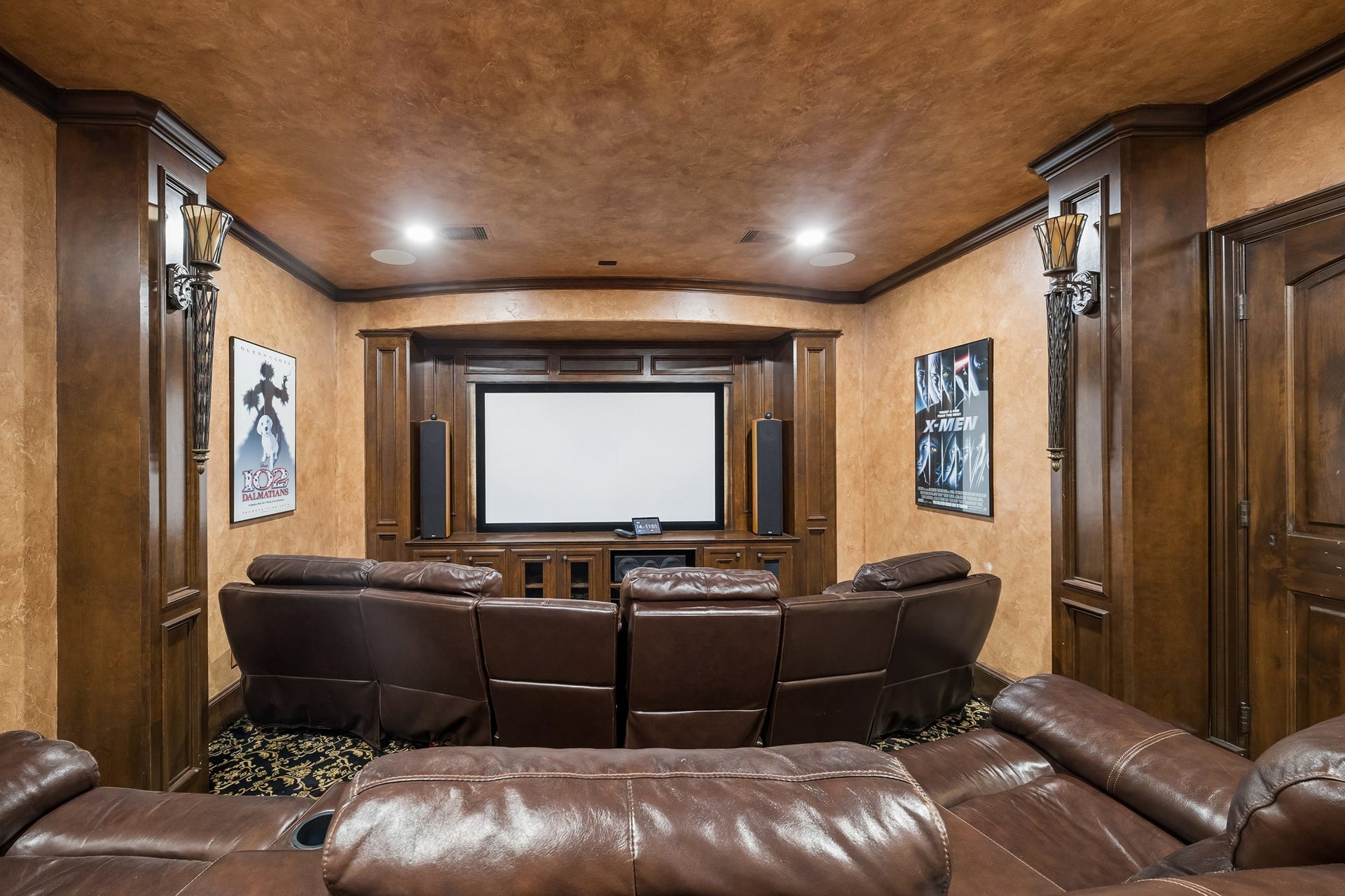 8111 Marshall Falls Drive, Spring, TX 77379 Luxurious home theater with top-of-the line AV equipment features plush leather recliners, rich wood paneling, and a large screen for the ultimate cinematic experience.