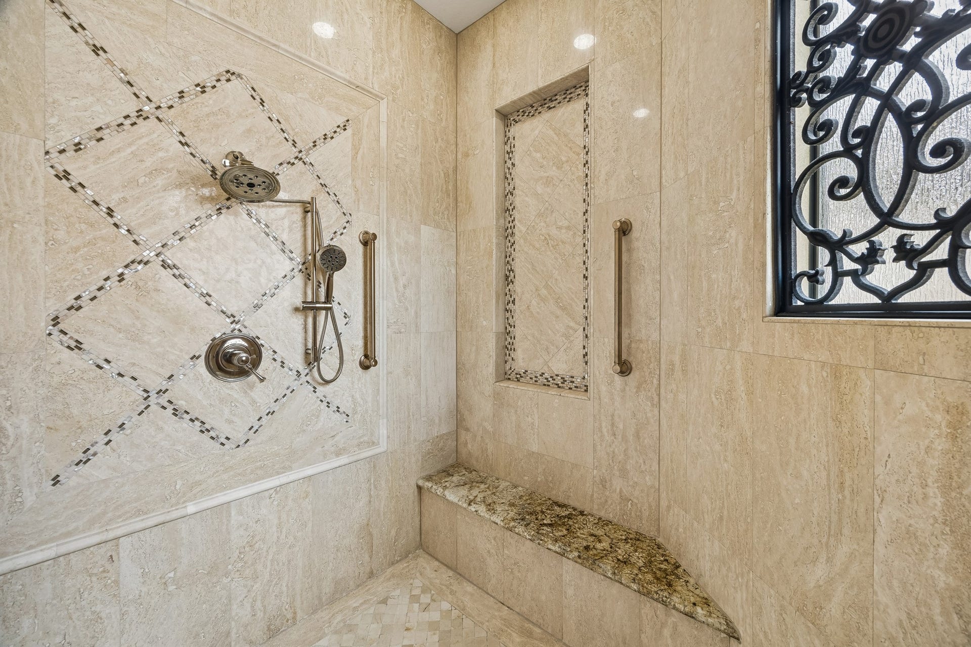 8111 Marshall Falls Drive, Spring, TX 77379 Luxurious shower featuring elegant tile work, a built-in bench, and a stylish wrought iron window for a touch of sophistication.