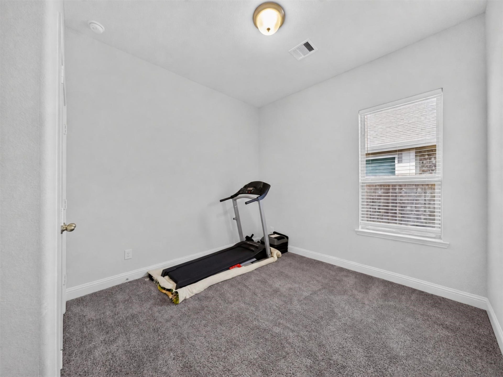 15419 Wilsons Snipe Court, Cypress, TX 77433 A comfortable first-floor secondary bedroom with carpet that works equally well for a bedroom, guest space or another flexible room.