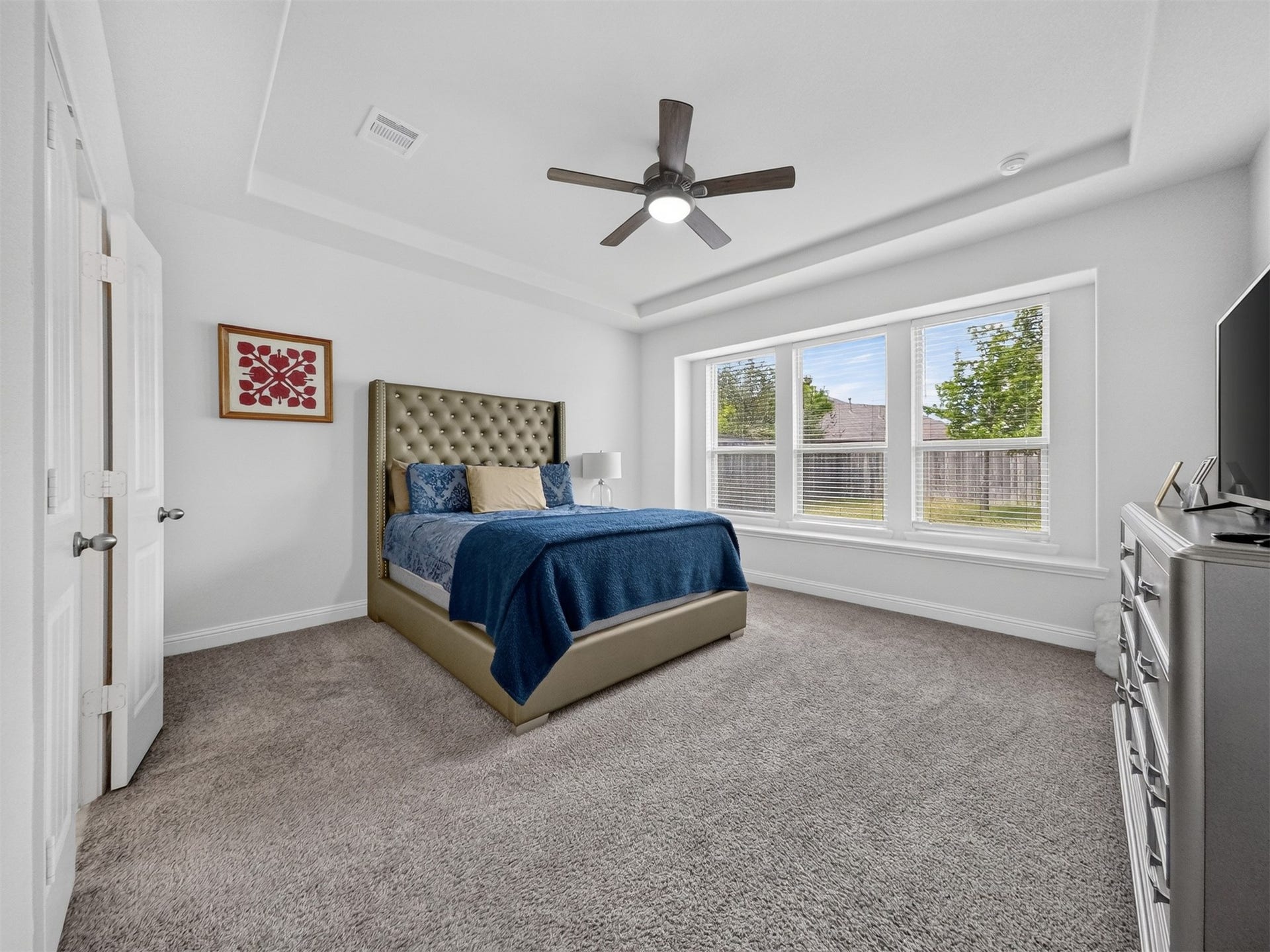 15419 Wilsons Snipe Court, Cypress, TX 77433 The downstairs primary bedroom offers high ceilings, a ceiling fan, soft carpet and backyard views, keeping the owner's suite comfortably separated from the upstairs living space