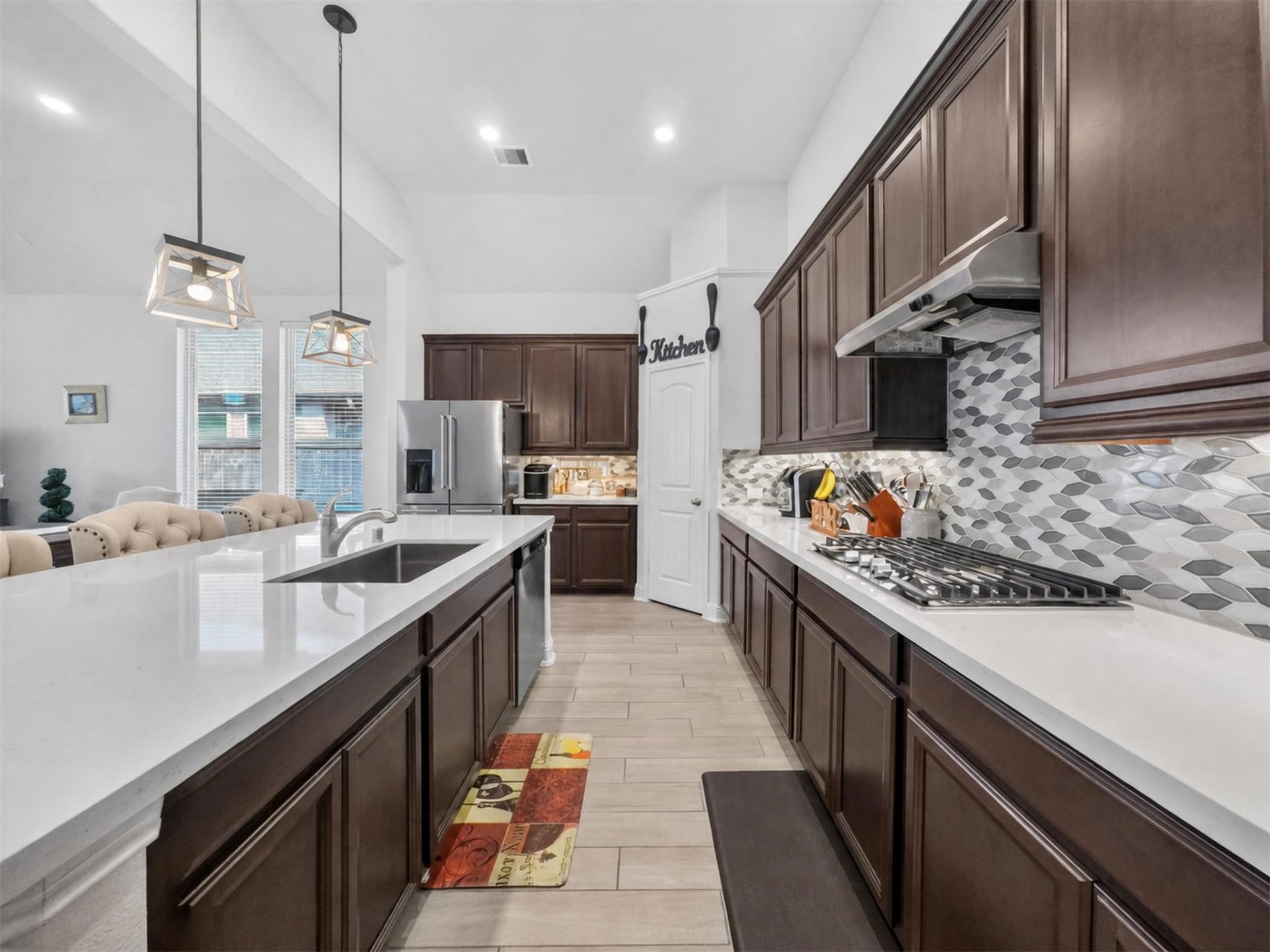 15419 Wilsons Snipe Court, Cypress, TX 77433 Quartz countertops, stainless steel appliances, extensive counter space, gas cooking and lots of cabinetry make this kitchen as practical as it is good-looking.
