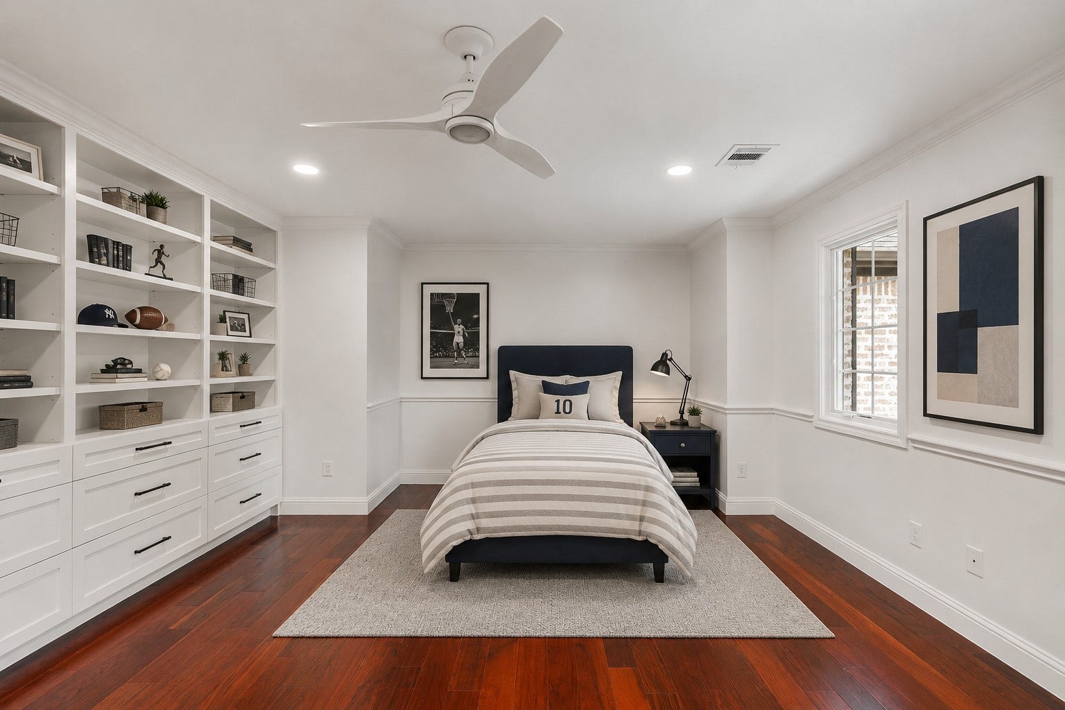 11407 Holidan Way, Hedwig Village, TX 77024 Generously sized upstairs secondary bedroom #4 highlighted by a wall of built-ins w/ drawers & open book/display shelving. Windows overlook the front yard, while recessed lighting, ceiling fan w/ light & a remodeled walk-in closet complete the space. Virtually staged.