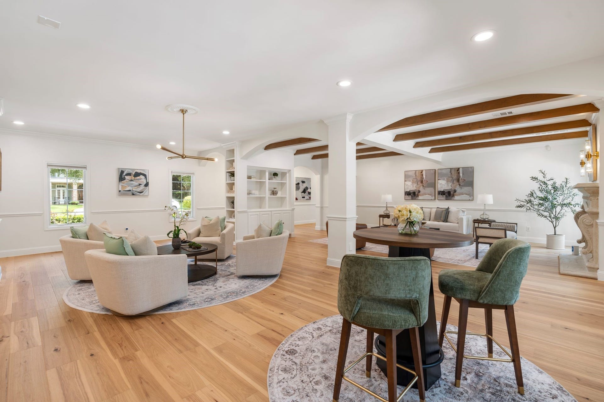 11407 Holidan Way, Hedwig Village, TX 77024 Another perspective highlighting the opened floor plan, reimagined in 2026, allowing the main living spaces to feel connected while maintaining beautifully defined areas. Notice the accent wood beams recently added in the living room.