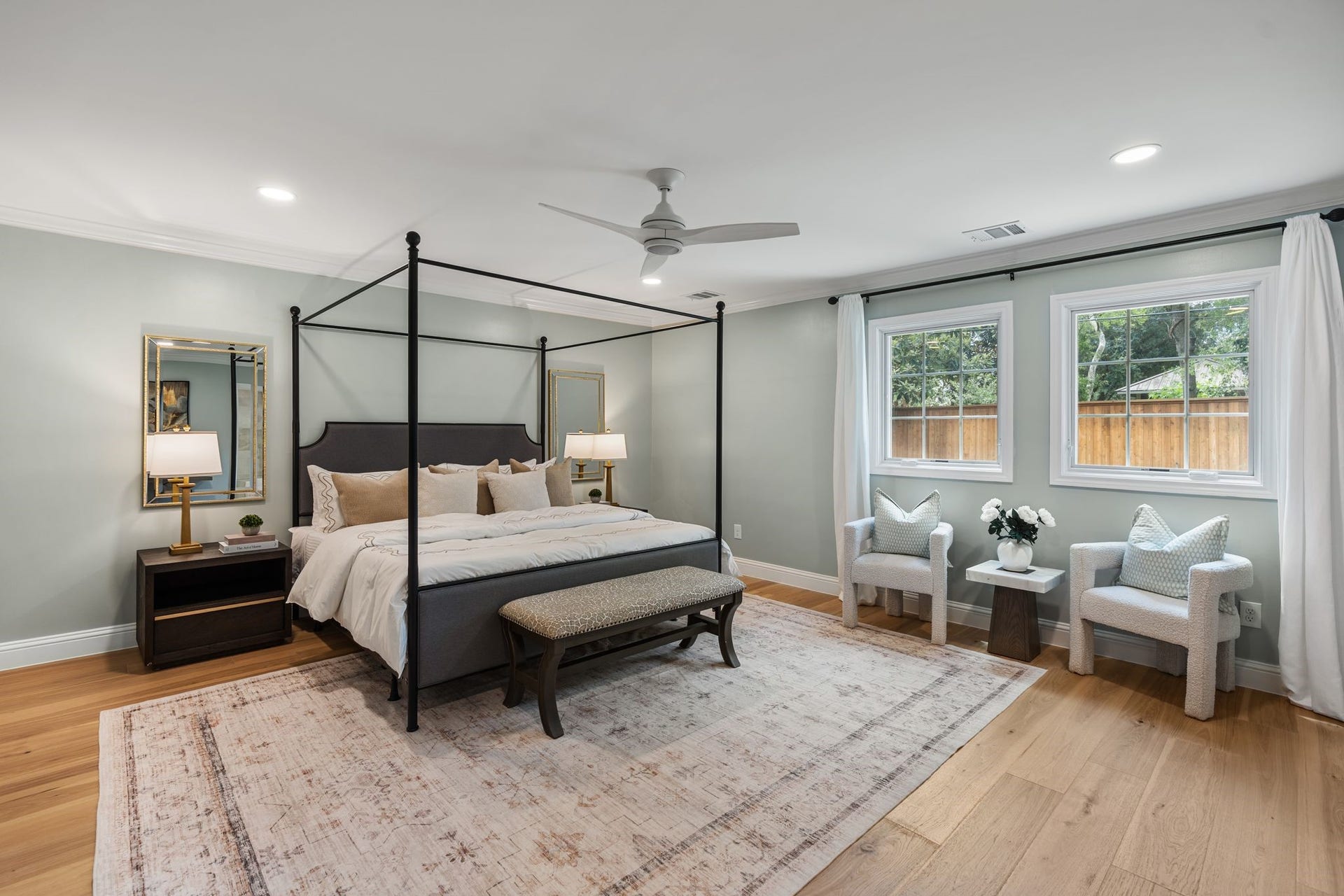 11407 Holidan Way, Hedwig Village, TX 77024 Serene first-floor primary suite tucked away for added privacy & offering generous proportions for large furnishings plus a sitting area. Crown molding, recessed lighting, ceiling fan w/ light & custom drapes create a comfortable, refined retreat. En suite bath.