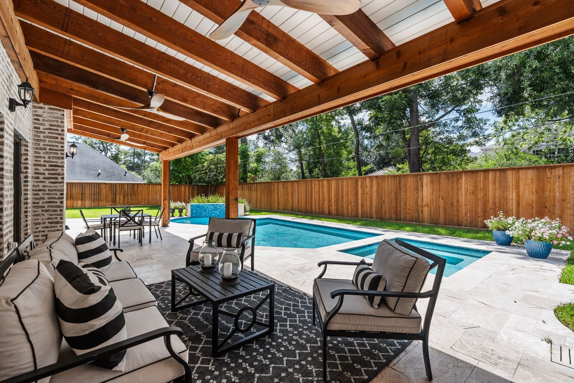 11407 Holidan Way, Hedwig Village, TX 77024 Your very own resort style backyard! Expansive covered back patio added in 2025 creates an incredible outdoor living space for year-round enjoyment. Three outdoor ceiling fans provide added comfort, while the open connection to the pool, patio & green space makes this an ideal setting for entertaining.