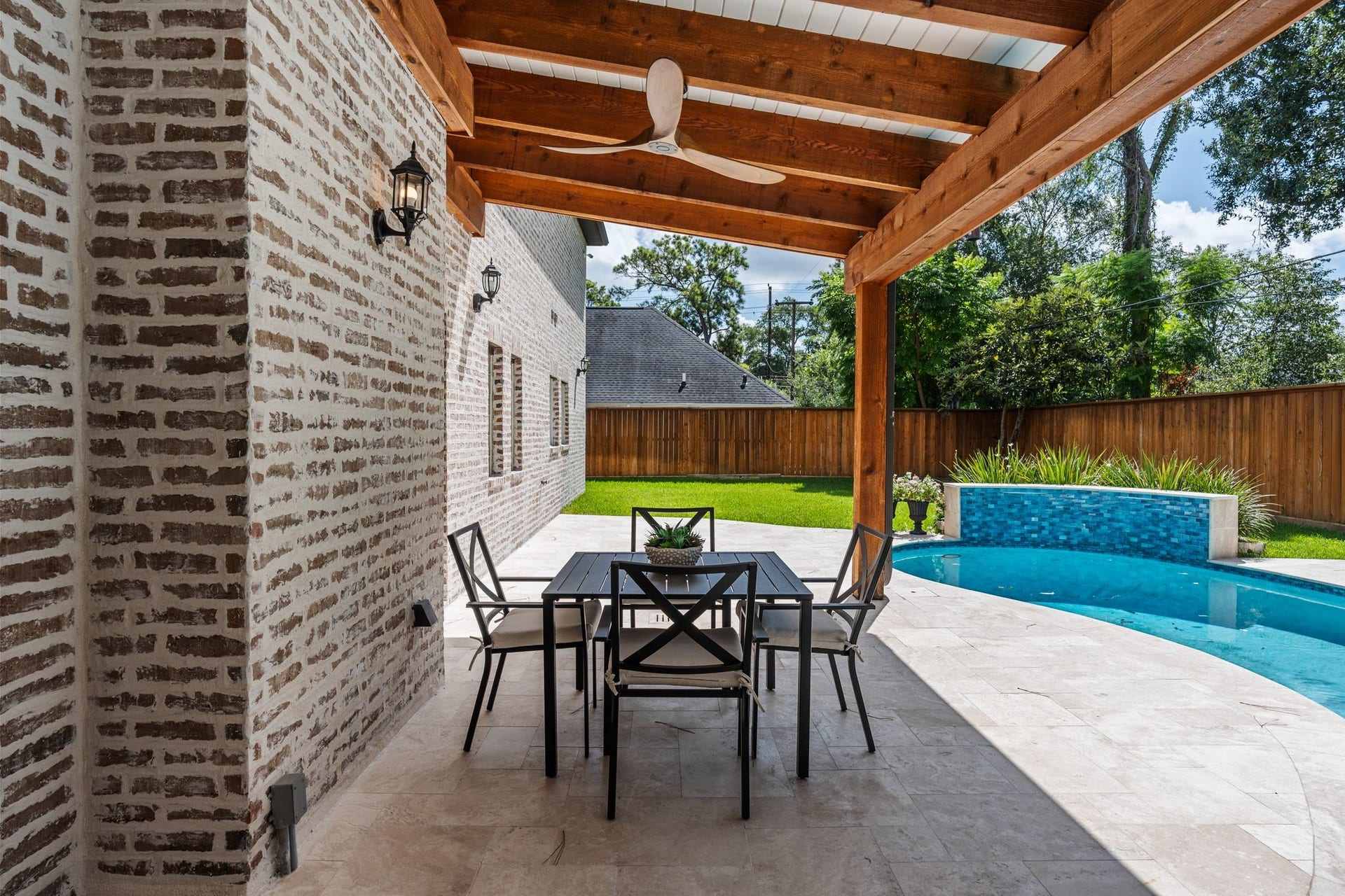 11407 Holidan Way, Hedwig Village, TX 77024 Another perspective of the impressive covered patio overlooking the sparkling pool & beautifully updated backyard. Generous proportions allow for multiple outdoor seating & dining configurations, creating a seamless extension of the homes living spaces.