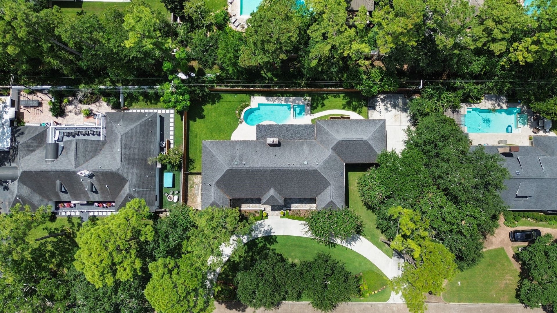 11407 Holidan Way, Hedwig Village, TX 77024 Aerial perspective showcases the impressive scale of this 23,492 SF property, per HCAD, w/ expansive residence, sparkling pool, covered patio, generous green space & motor court. An exceptional setting nestled in the heart of desirable Hedwig Village. Schedule your showing today!