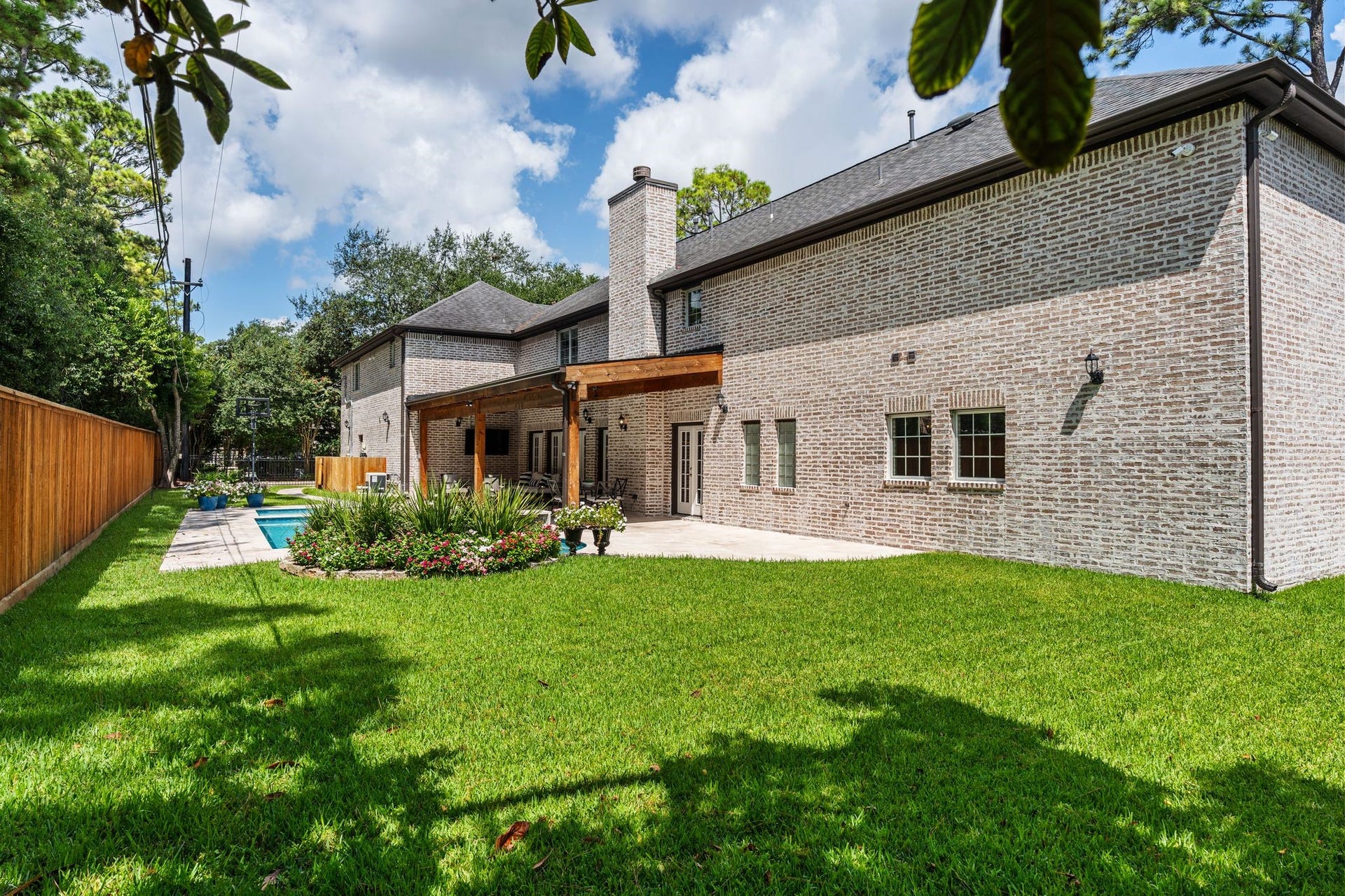 11407 Holidan Way, Hedwig Village, TX 77024 Expansive green space provides plenty of room for pets & play, framed by a cedar backyard fence installed in 2021. Gutters and sprinkler system provide easy maintenance.