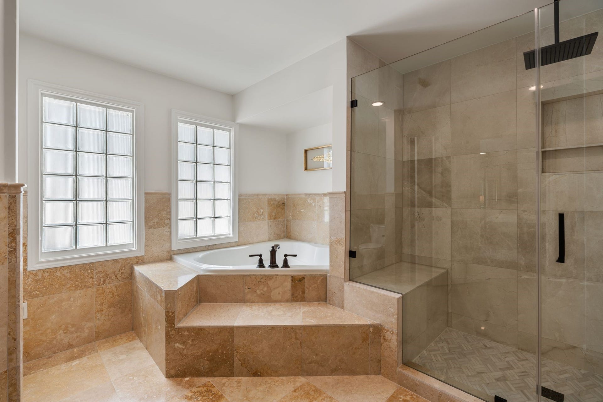 11407 Holidan Way, Hedwig Village, TX 77024 Your private primary retreat continues w/ an oversized jetted tub & large separate shower featuring a frameless glass door, rainfall showerhead & wall-mounted showerhead. A beautifully appointed space offering the perfect place to unwind.