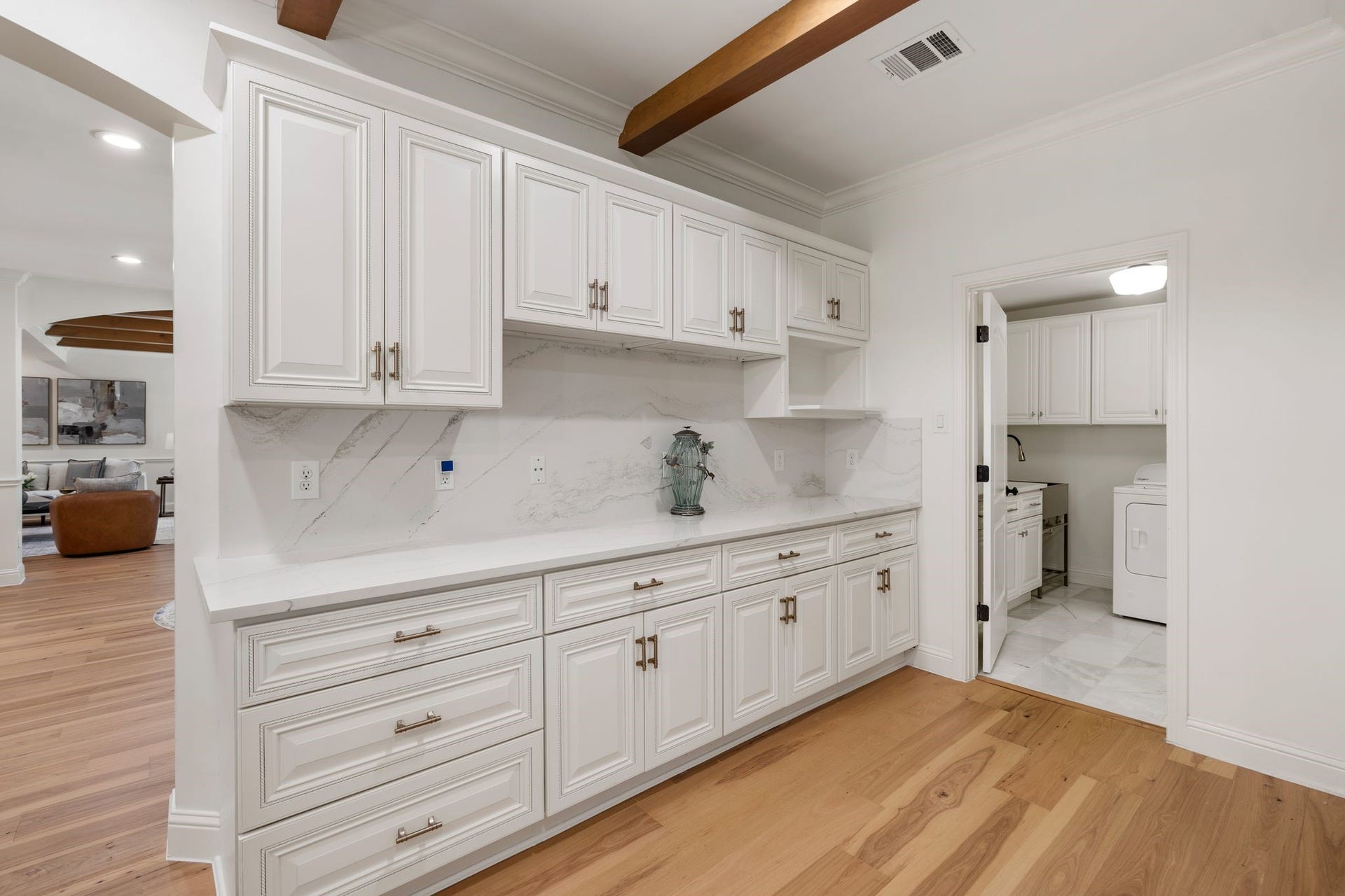 11407 Holidan Way, Hedwig Village, TX 77024 View showing the extension of the kitchen's ample storage. Dedicated space for a future microwave. Door to right leads to the utility room and attached garage.