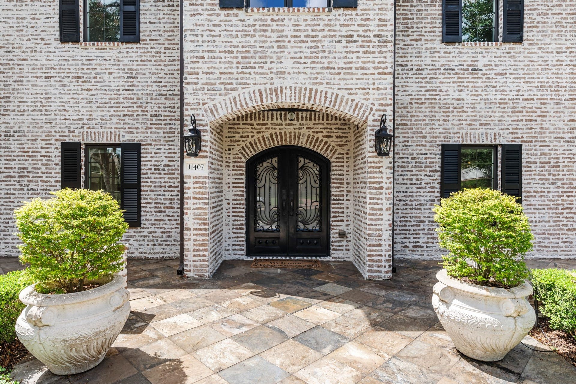 11407 Holidan Way, Hedwig Village, TX 77024 Welcoming front porch with arched covered entrance leads to impressive double entry doors w/ decorative wrought iron panel fronts. The German smear exterior & manicured landscaping beautifully frame the entrance & set the tone for this extensively updated Hedwig Village residence.