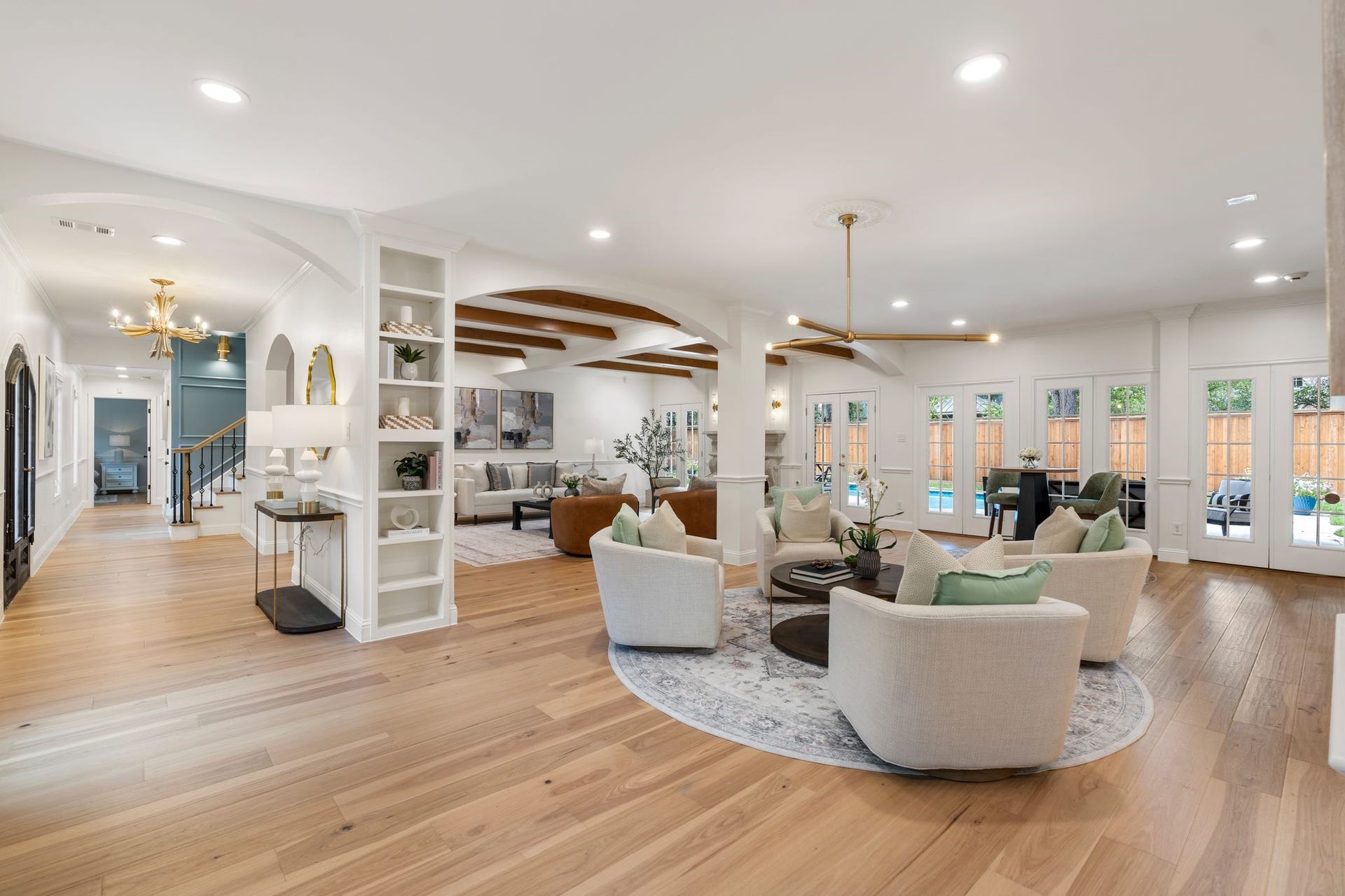11407 Holidan Way, Hedwig Village, TX 77024 A beautiful perspective showcasing the homes thoughtfully reimagined first-floor layout: Notice the wall of windows overlooking the backyard, filling the space w/ natural light. Designed for elevated everyday living & entertaining.