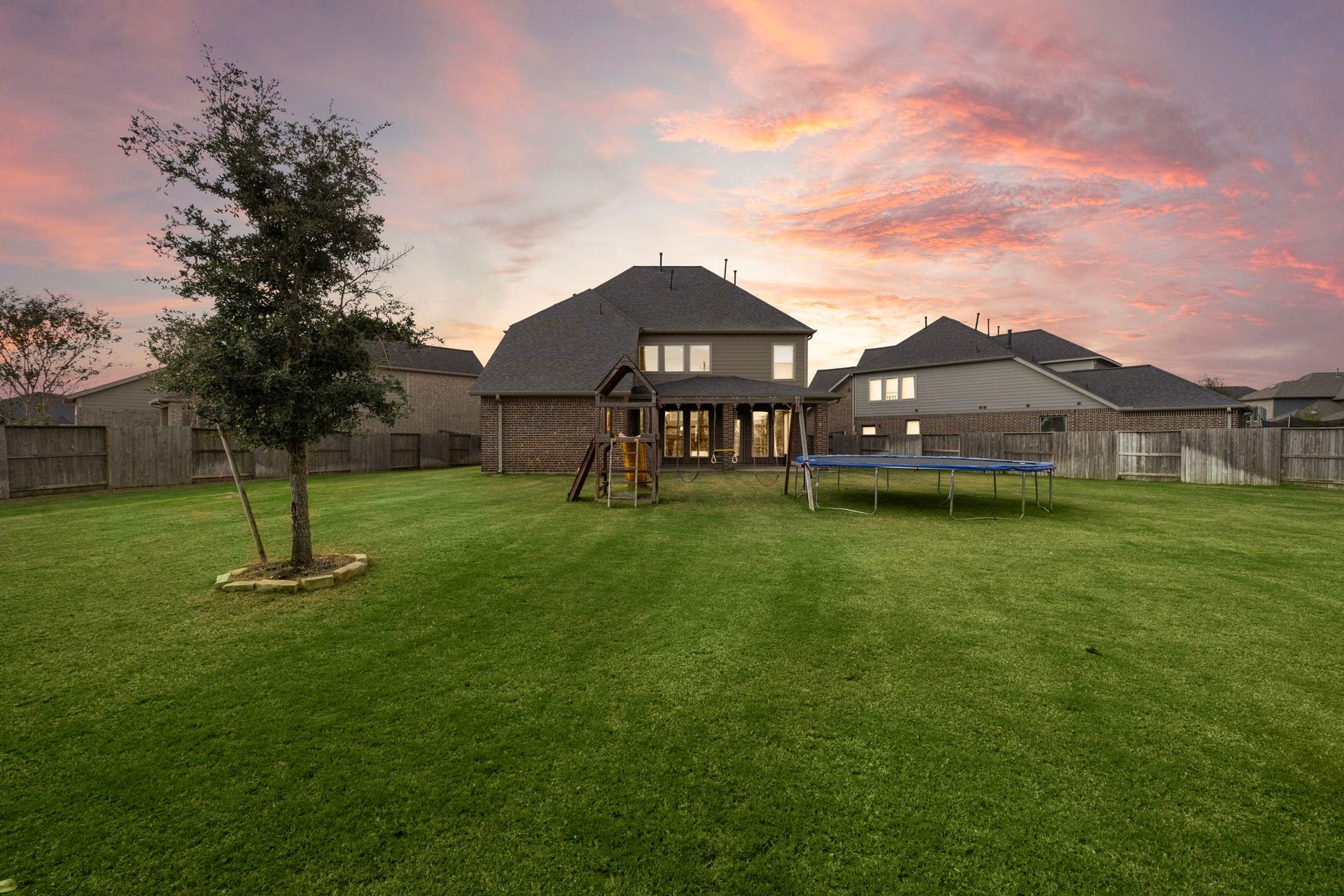 6902 N Elmwood Trail, Katy, TX 77493 A spacious, fully fenced backyard offering plenty of room for outdoor entertaining, play, pets or creating your own private retreat.