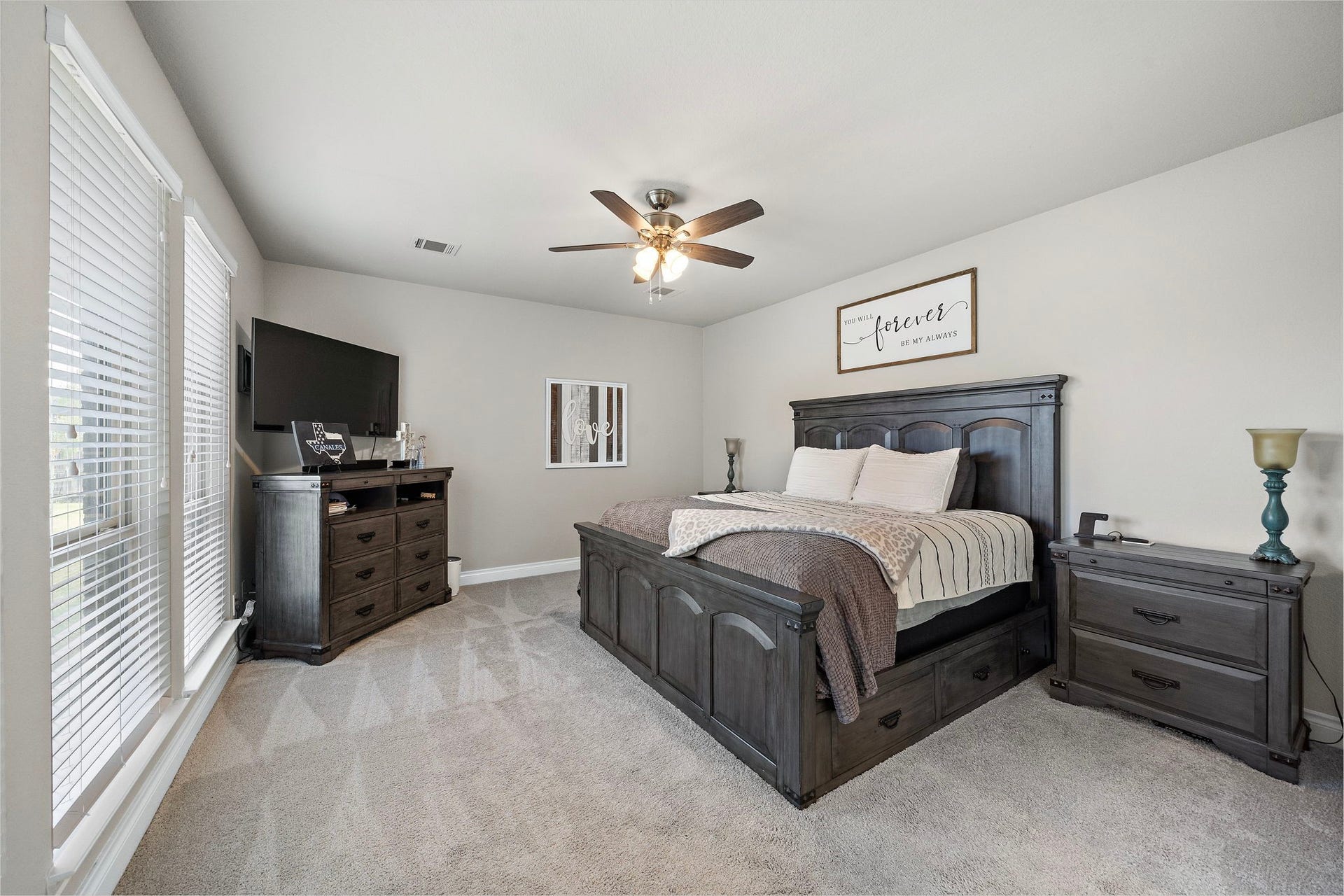 6902 N Elmwood Trail, Katy, TX 77493 A generously sized primary bedroom featuring a ceiling fan, soothing neutral tones and a private en suite bath.