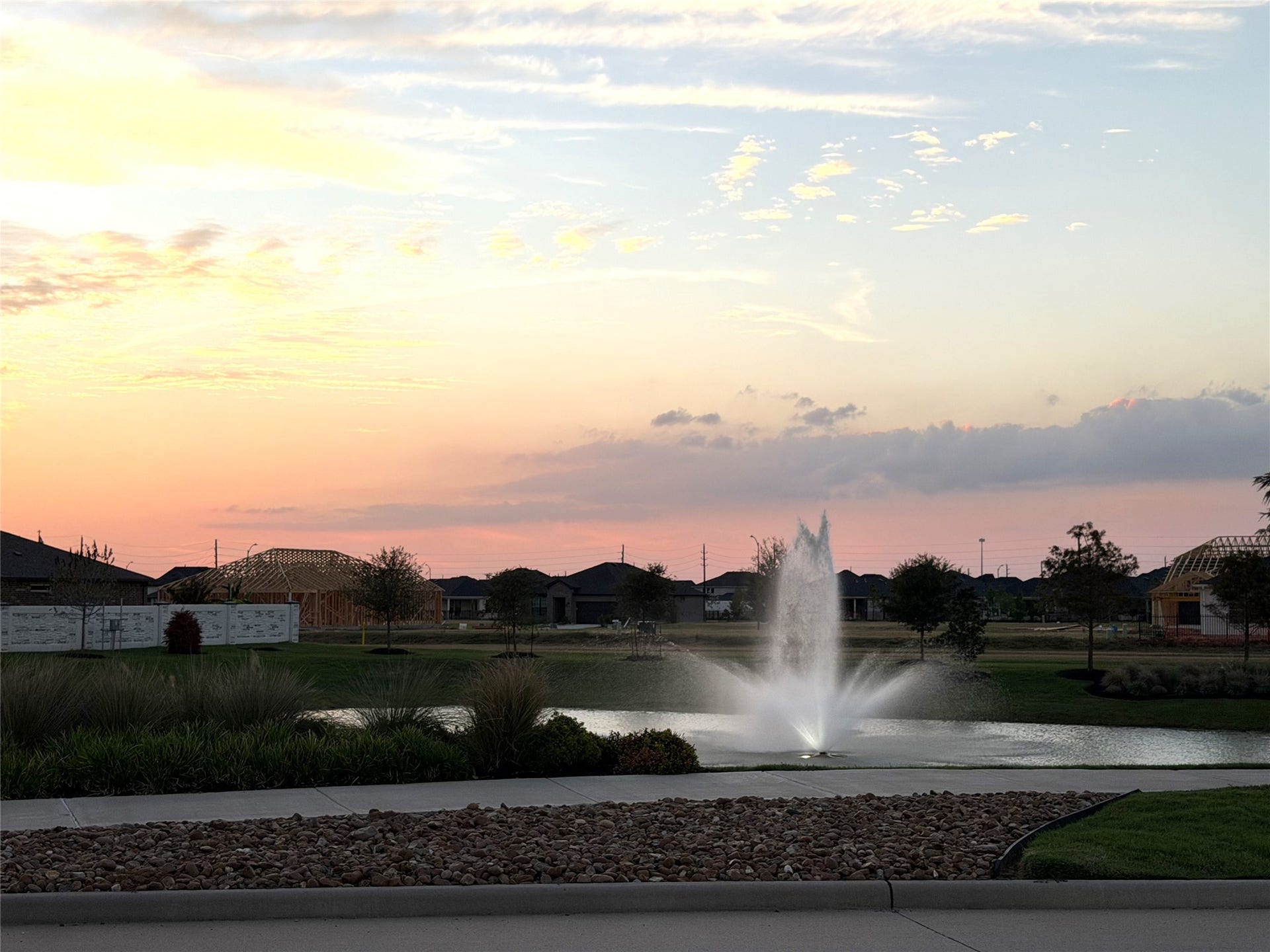 8015 Prospect Drive, Fulshear, TX 77441 Picture peaceful evenings beside the community's sparkling fountain, surrounded by beautifully maintained grounds. Soft sunset colors create a picturesque setting to enjoy the beauty of Del Webb Fulshear.
