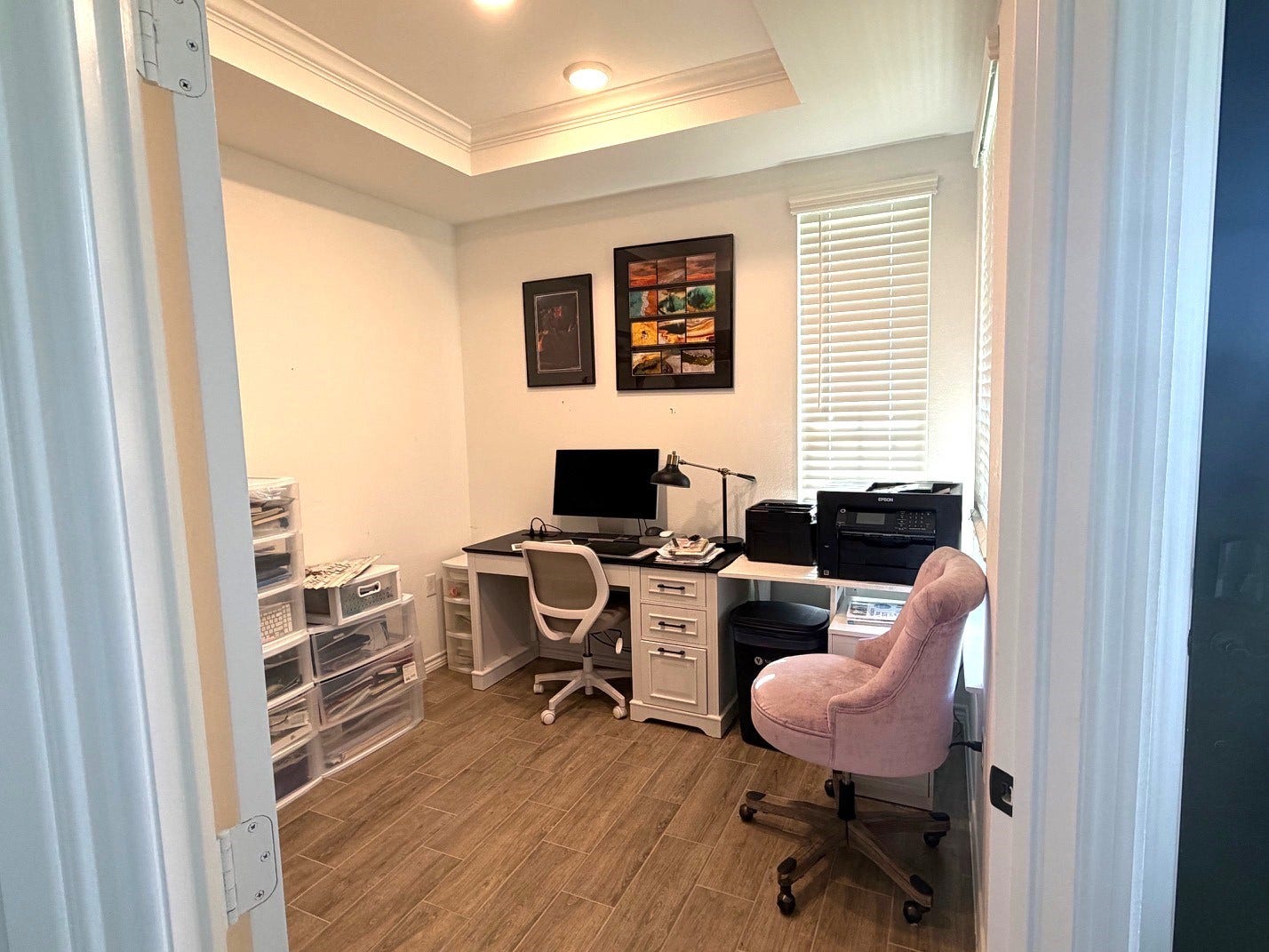 8015 Prospect Drive, Fulshear, TX 77441 Bright home office with elegant tray ceilings, recessed lighting, and a large window. A dedicated workspace offers comfort and privacy for working from home.