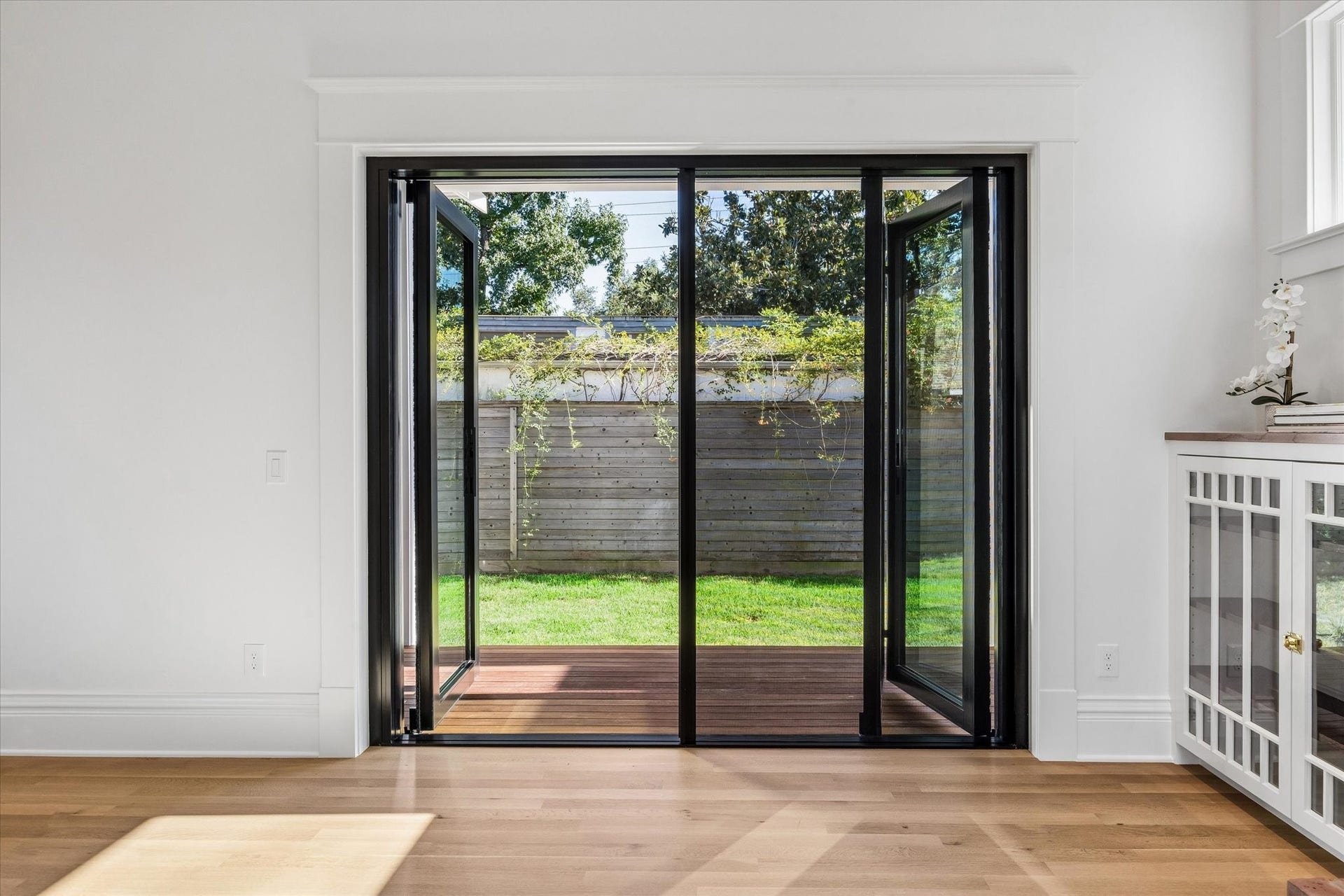 1203 Heights Boulevard, Houston, TX 77008 Close up the steel doors. One swings open and the other two fold to the right side. The screen slides out from the right.
