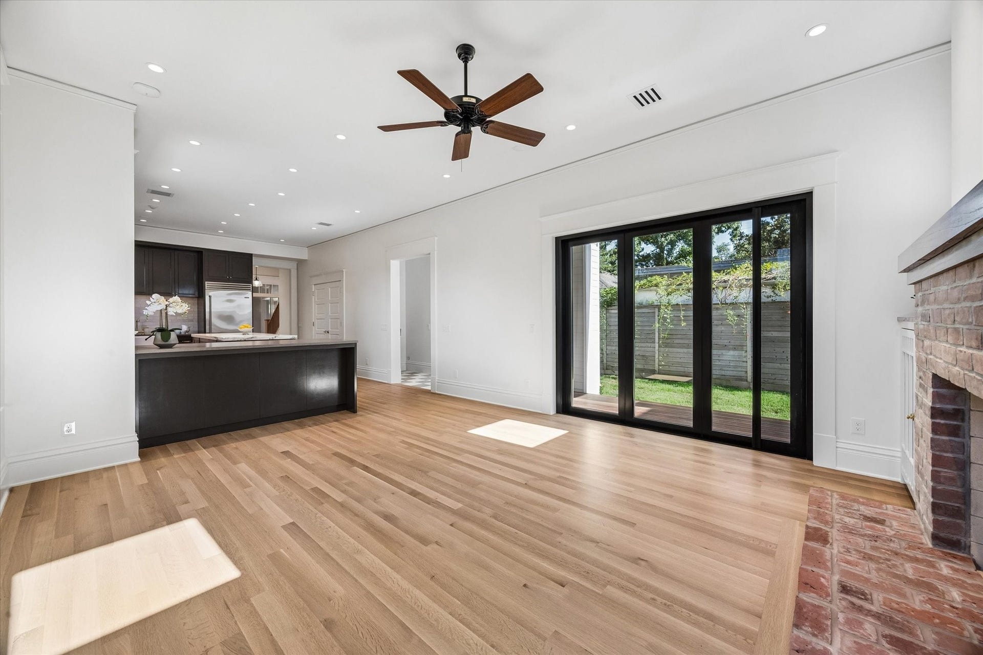 1203 Heights Boulevard, Houston, TX 77008 The family room is right next to the kitchen and has a 3 doors folding system with a sliding screen door, that open to the side yard.