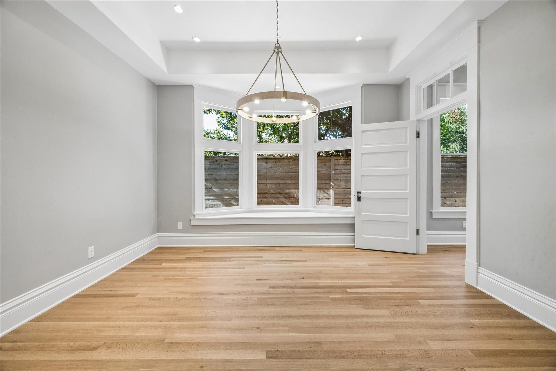 1203 Heights Boulevard, Houston, TX 77008 The dining room has a lovely bay window, a tray detail in the ceiling and a contemporary chandelier.