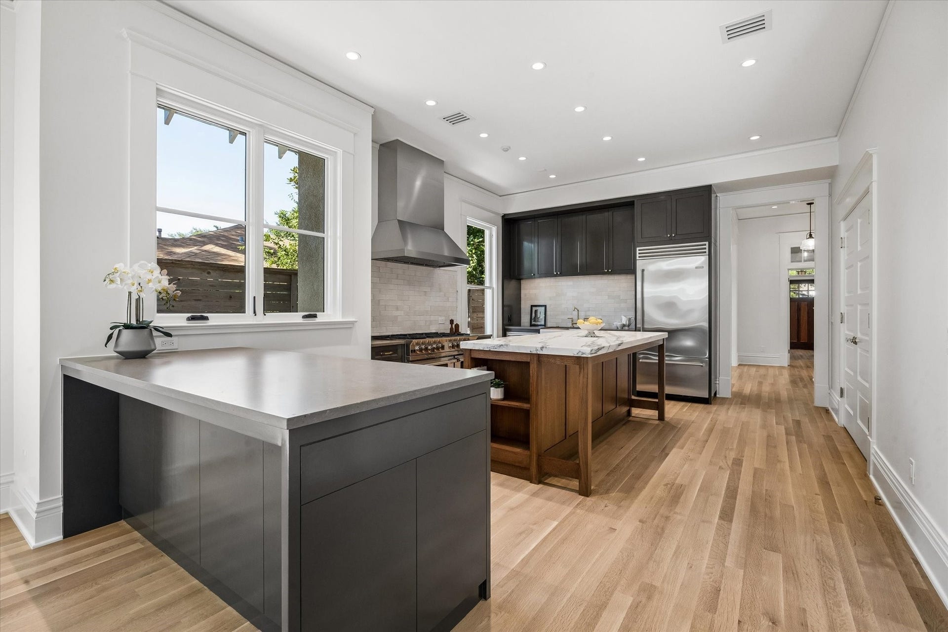1203 Heights Boulevard, Houston, TX 77008 Custom Kitchen with sleek Blue Star Appliances, tall ceilings, beautiful new hardwood floors. The counter tops are marble and granite.