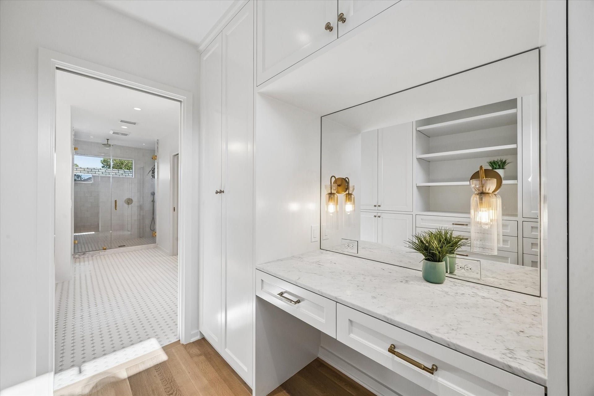 1203 Heights Boulevard, Houston, TX 77008 Primary closet #1 has built ins with a mirror and room for a vanity chair.