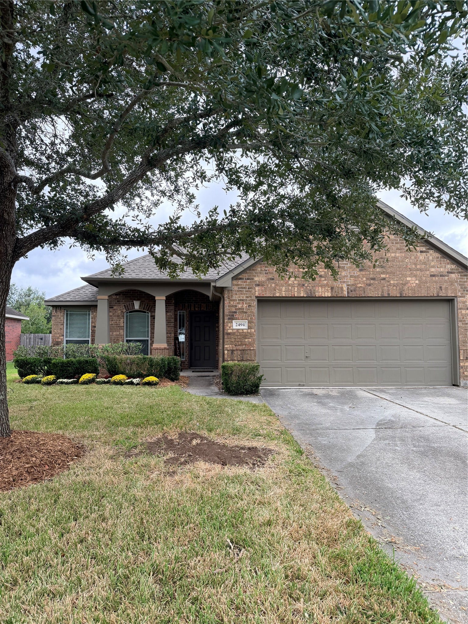 2494 Sandvalley Way, League City, TX 77573 Front elevation of home with mature shade tree