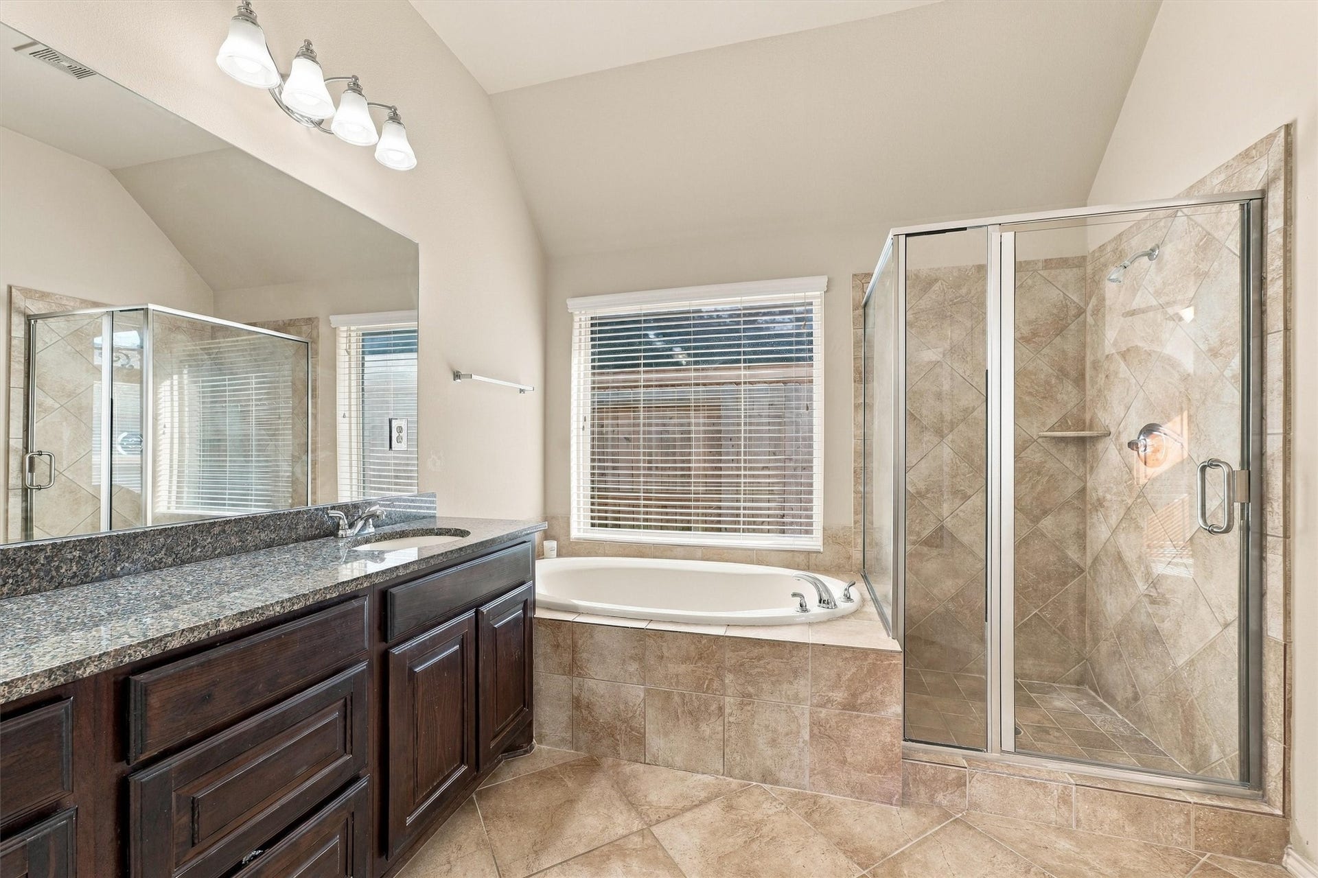 13415 Breakwater Path Loop, Houston, TX 77044 Observe the separate soaking tub and walk in shower with sturdy glass doors.