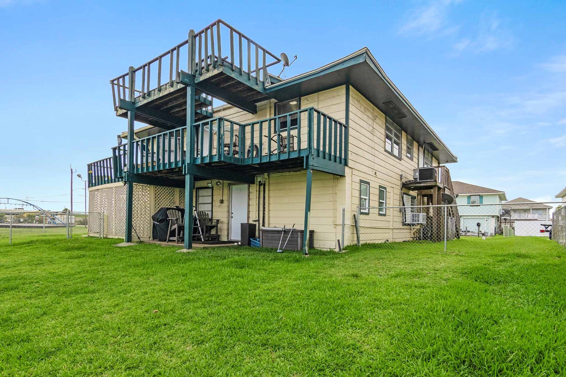 856 Bonita Street, Bayou Vista, TX 77563 Canal side of home showing deck on second floor and other deck above it. Great views from both decks!