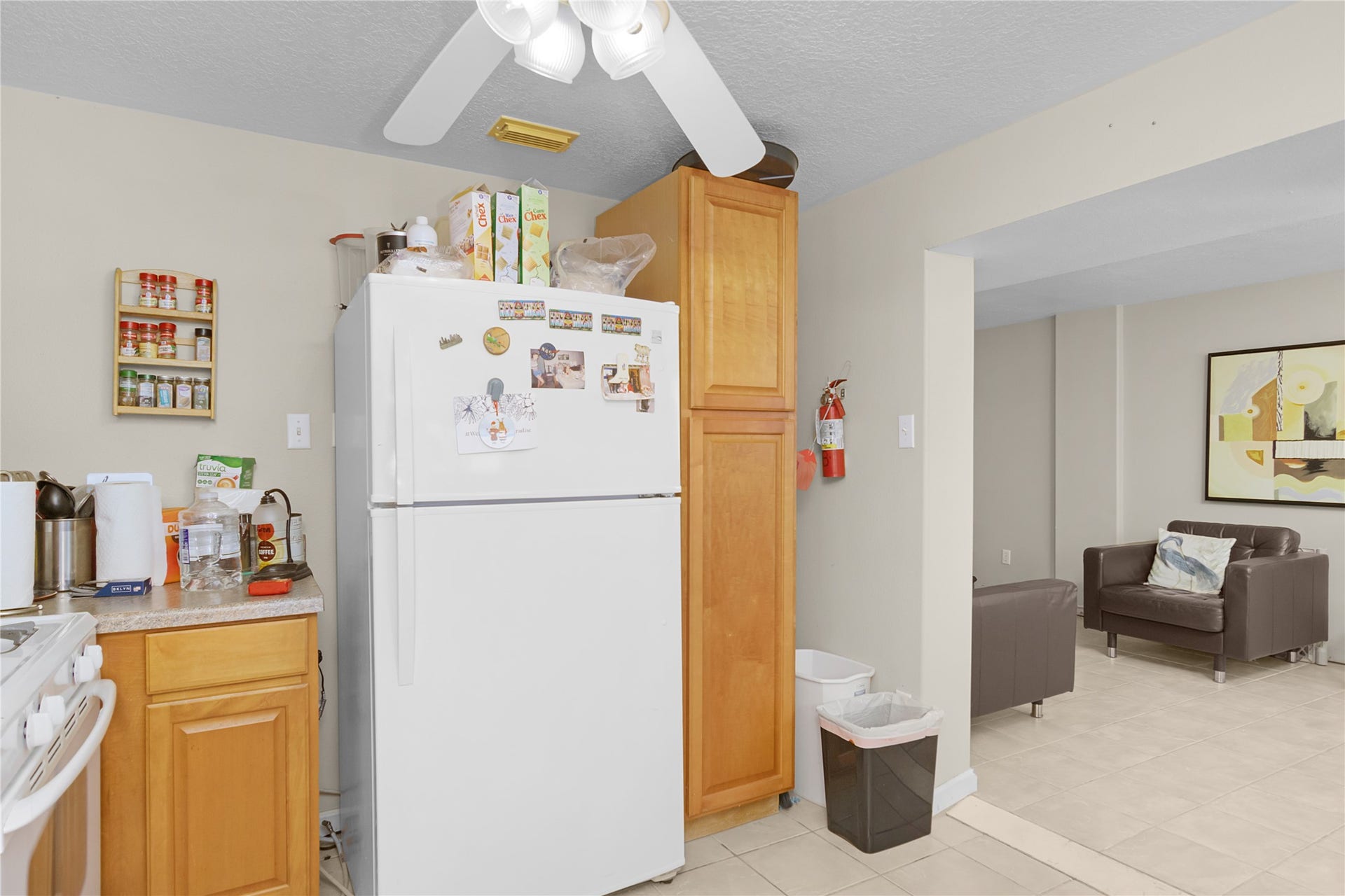 856 Bonita Street, Bayou Vista, TX 77563 Refrigerator, pantry in quarters and view of living room on left side.