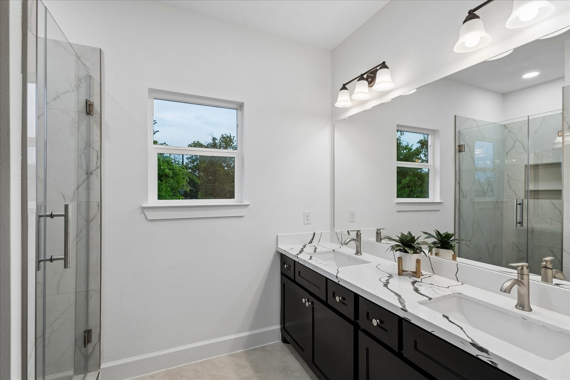 8715 Shotwell Street, #B, Houston, TX 77016 The beautifully appointed primary en-suite bathroom featuring dual vanities and a luxurious walk-in shower.
