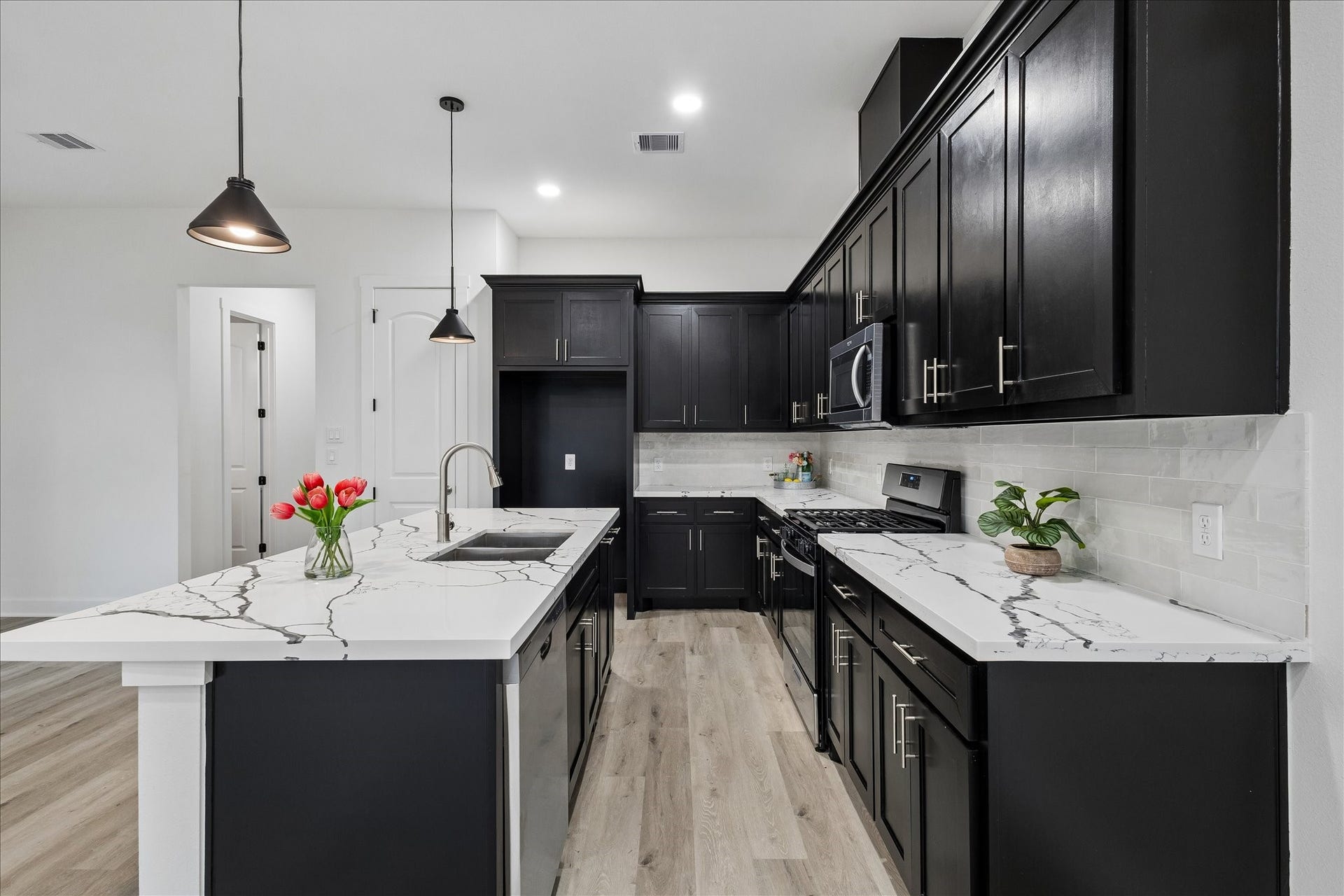 8715 Shotwell Street, #B, Houston, TX 77016 A stylish kitchen island offering additional functionality and the perfect space for barstool seating.