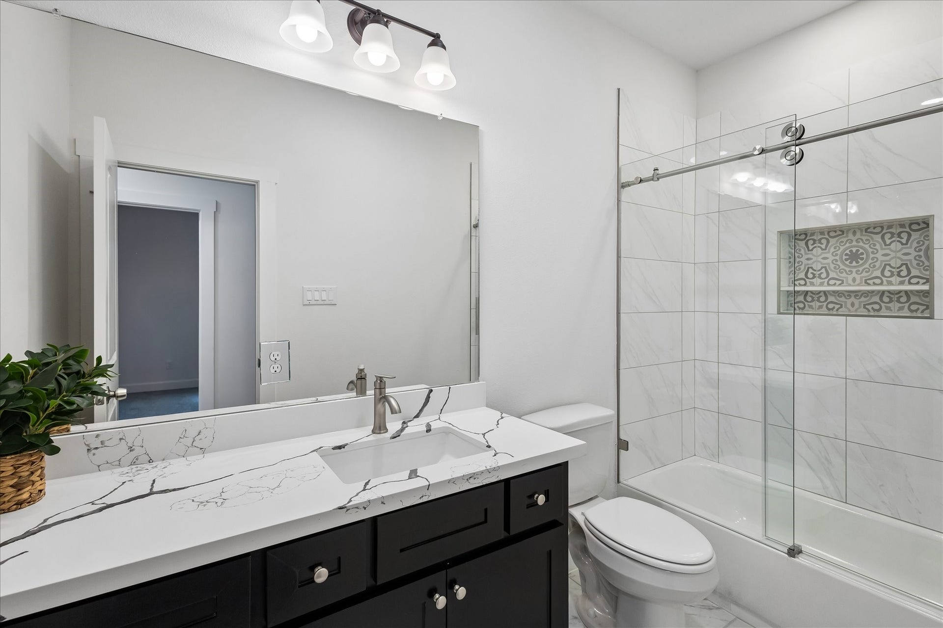 8715 Shotwell Street, #B, Houston, TX 77016 A beautifully appointed secondary bathroom featuring dual sinks for added comfort and convenience.