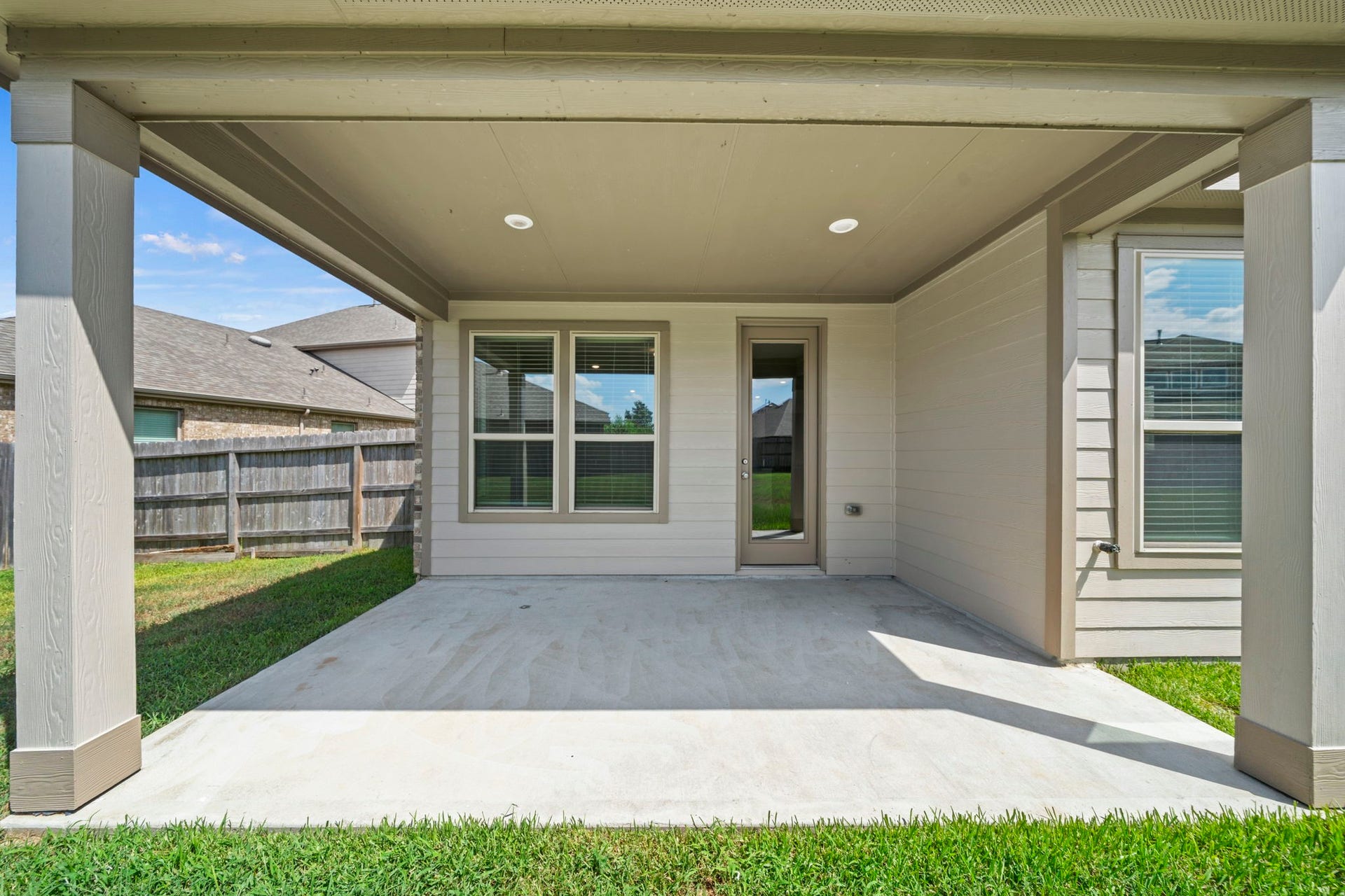 8908 Bear Mountain Court, Magnolia, TX 77354 Relax or entertain on this spacious covered back patio that offers seamless indoor-outdoor flow into your private backyard.