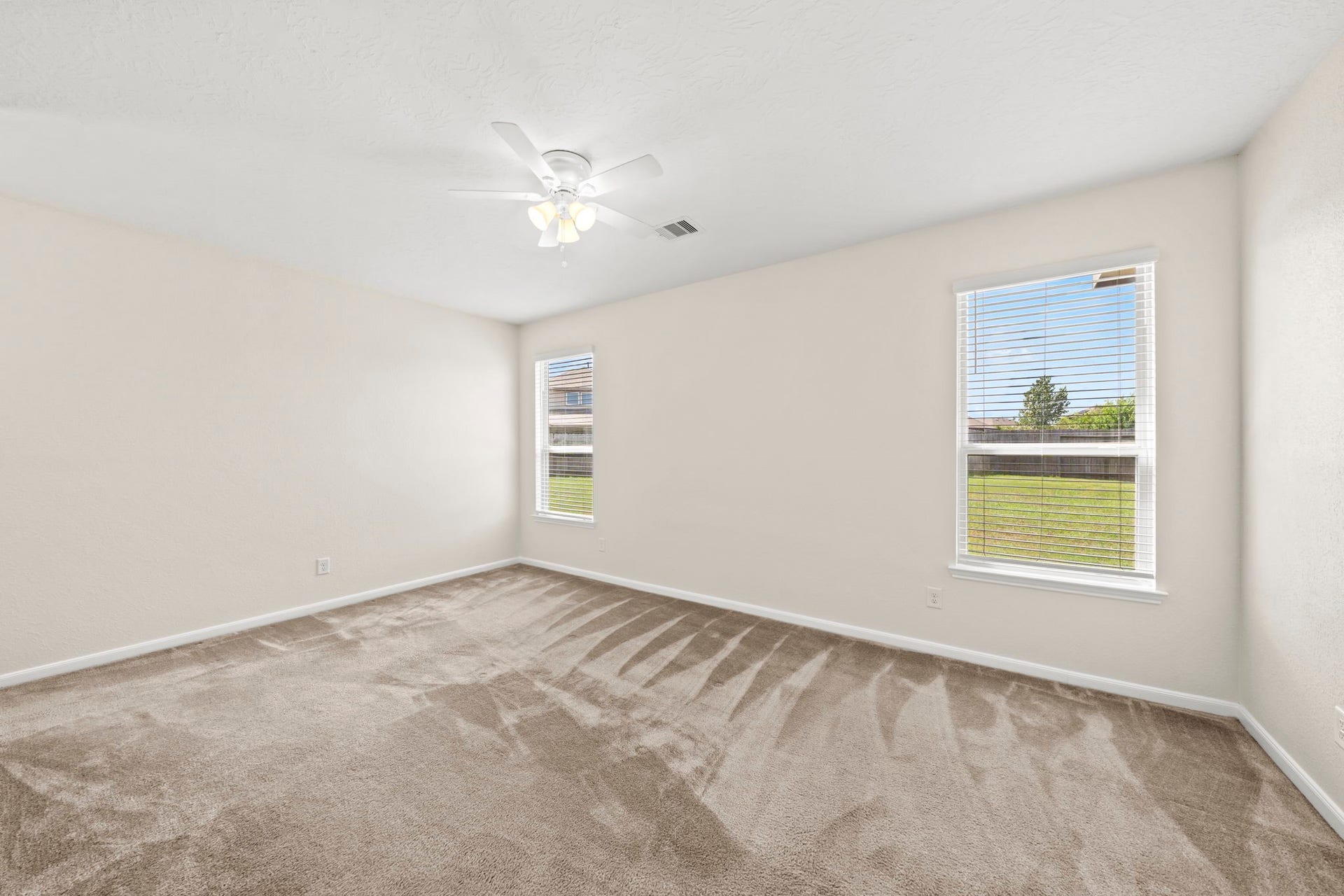 8908 Bear Mountain Court, Magnolia, TX 77354 Flooded with natural light, this restful retreat offers direct access to the private bathroom.