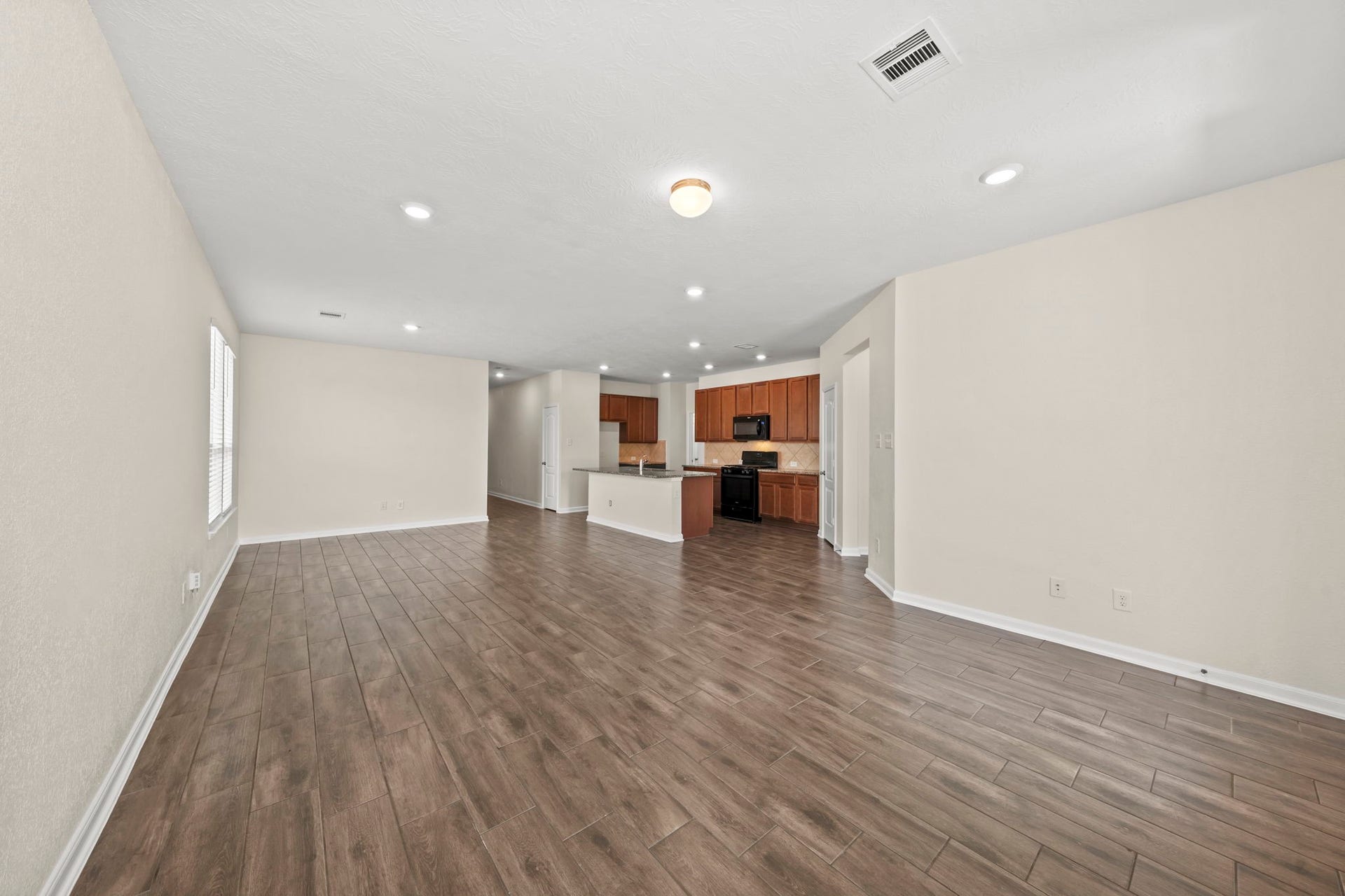8908 Bear Mountain Court, Magnolia, TX 77354 Offers an open and airy feel with a seamless flow directly into the adjoining kitchen.
