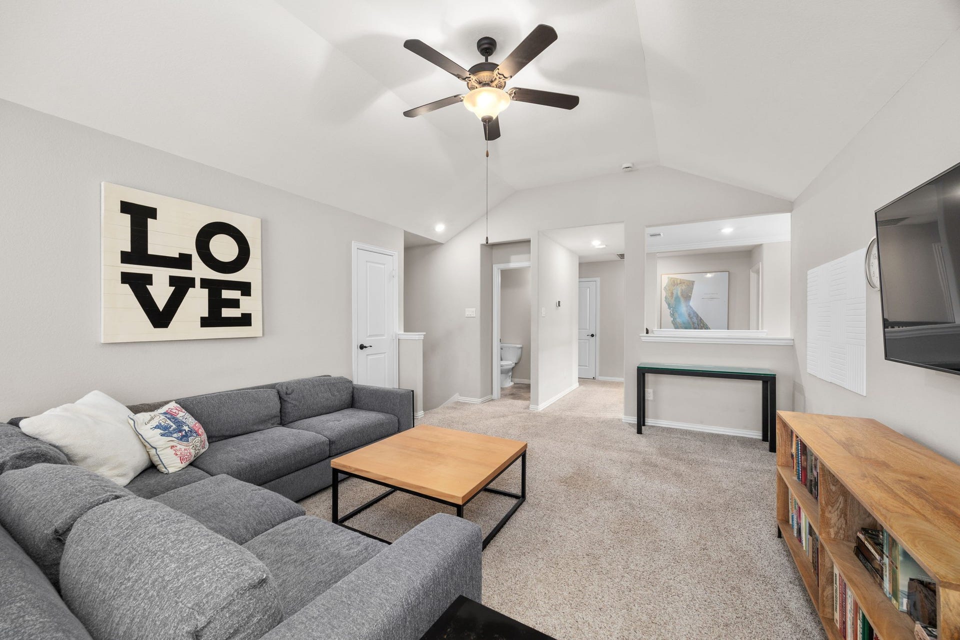 Gameroom with half bath and hallway leading to two guest bedrooms.