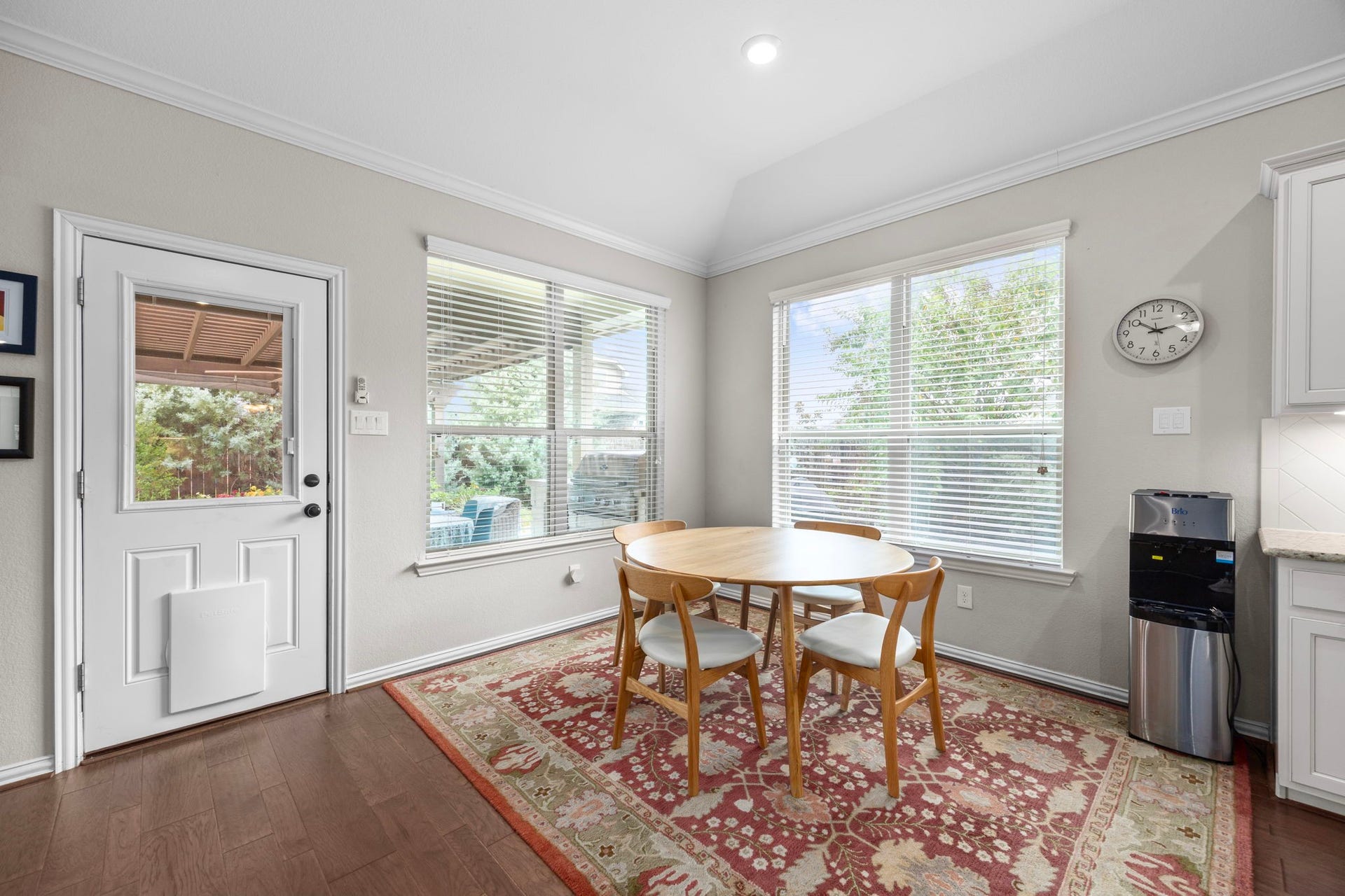 Bright breakfast nook with large windows.