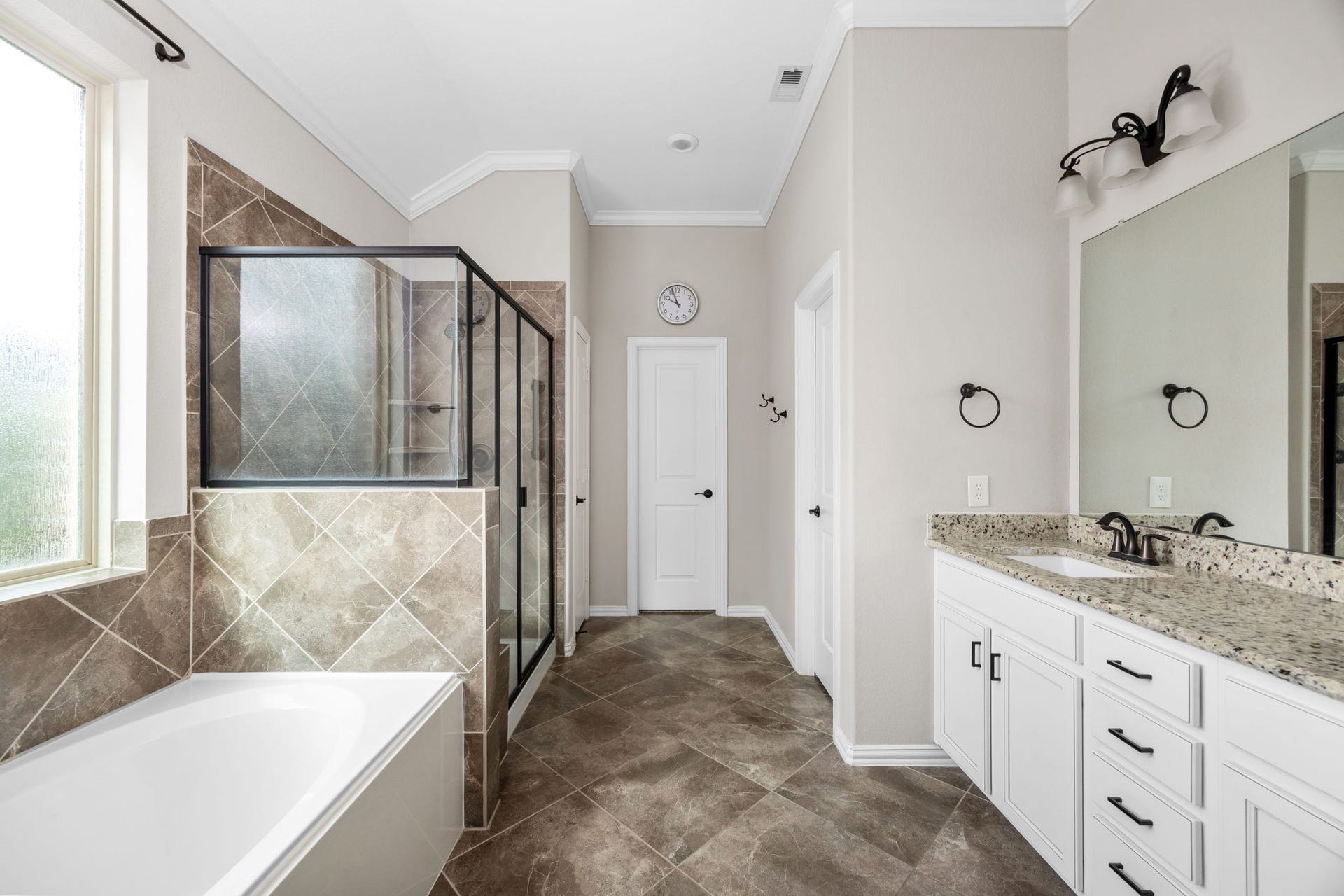 Primary bathroom with double sinks, soaker tub and separate walk in shower.