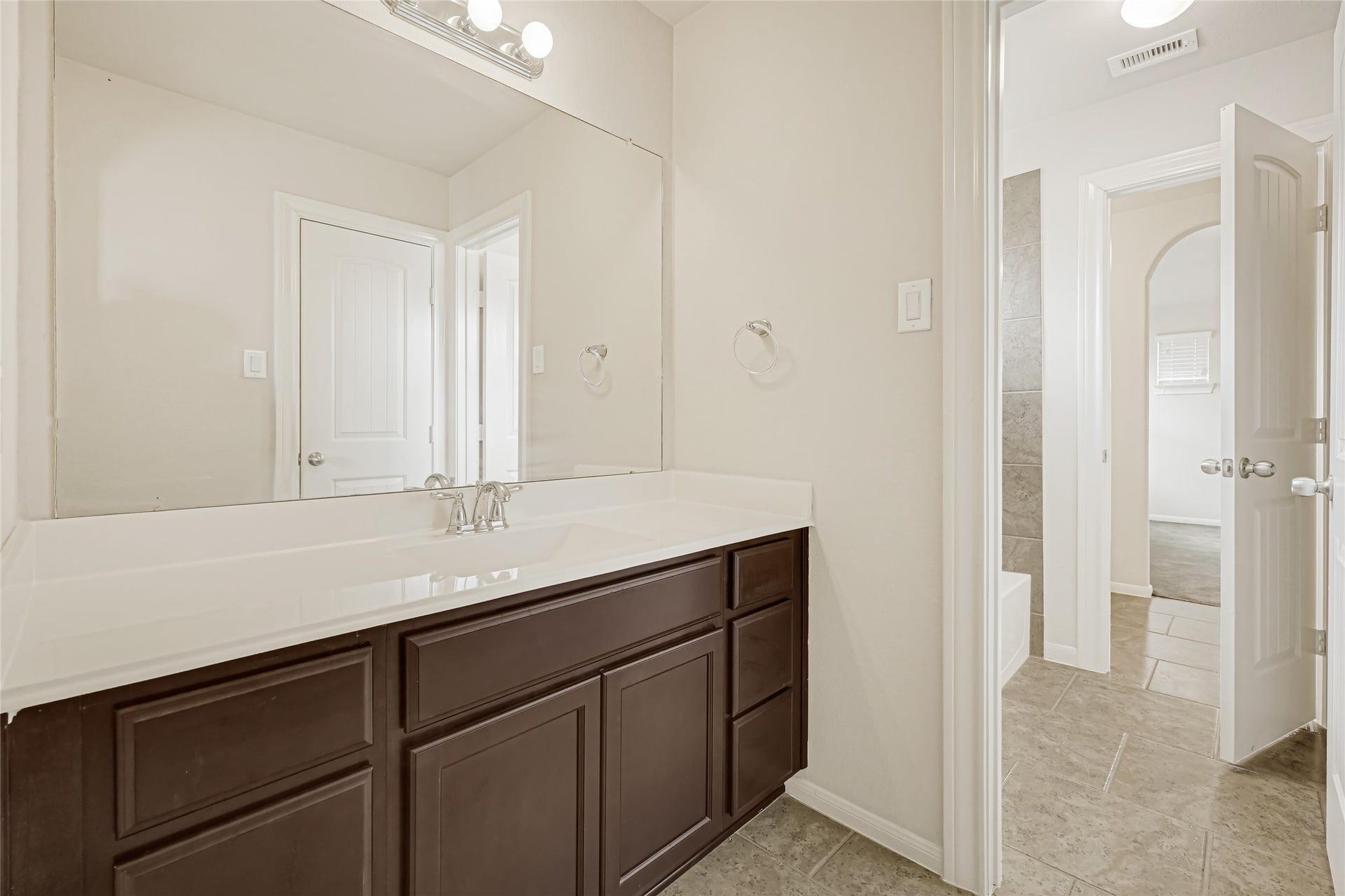 736 Somerset Landing Lane, League City, TX 77573 Long vanity with dark cabinetry, ample counter space, and a bright neutral finish.