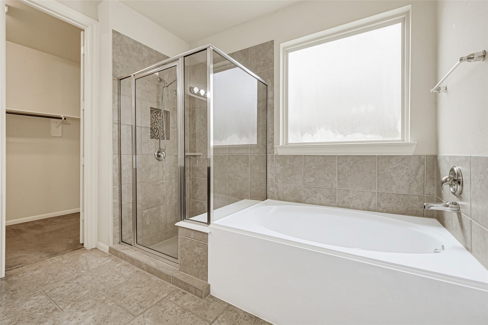 736 Somerset Landing Lane, League City, TX 77573 Relaxing primary bath with a soaking tub, separate glass-enclosed shower, and natural light.